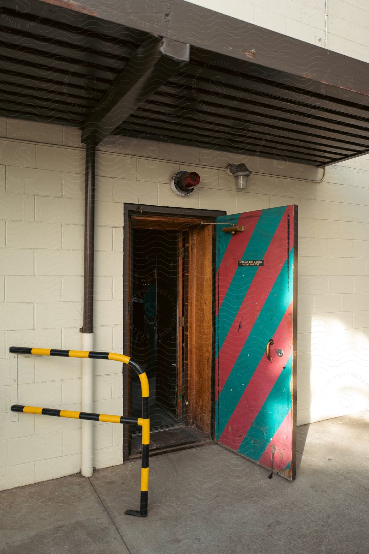 Exterior building with open door next to safety fence