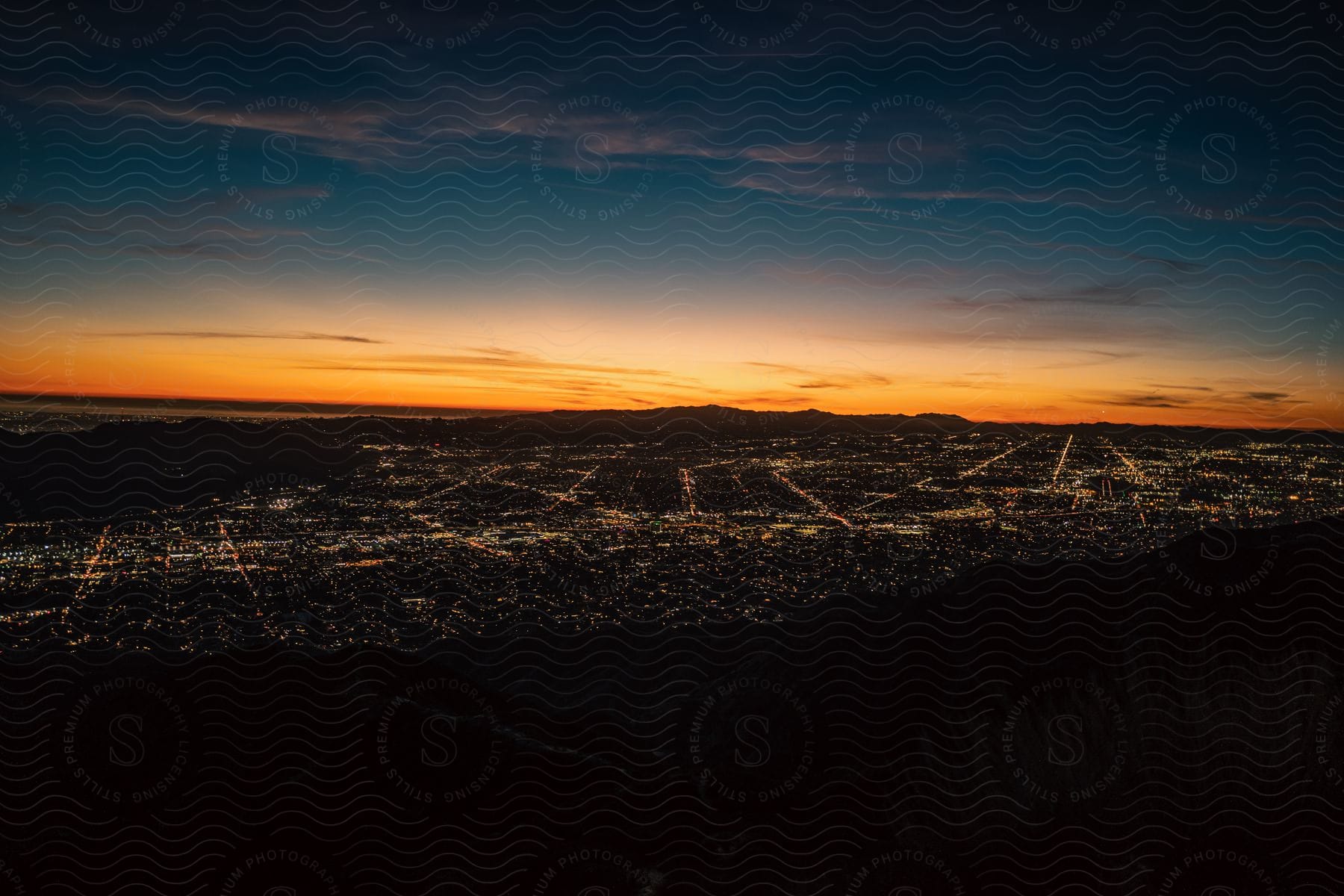 Aerial shot of the sun setting over a wide horizon