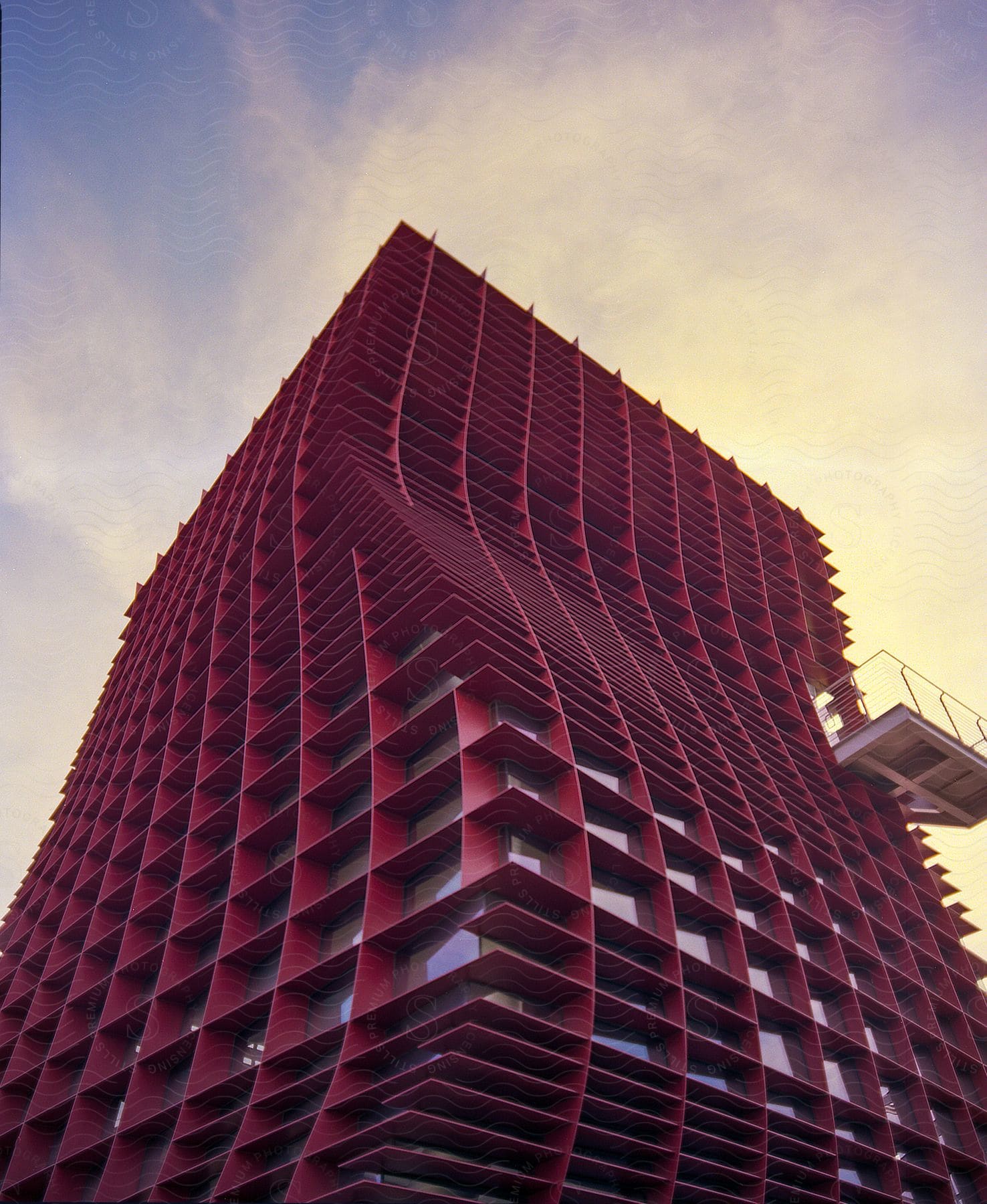 An urban highrise apartment building made of reed material with numerous windows