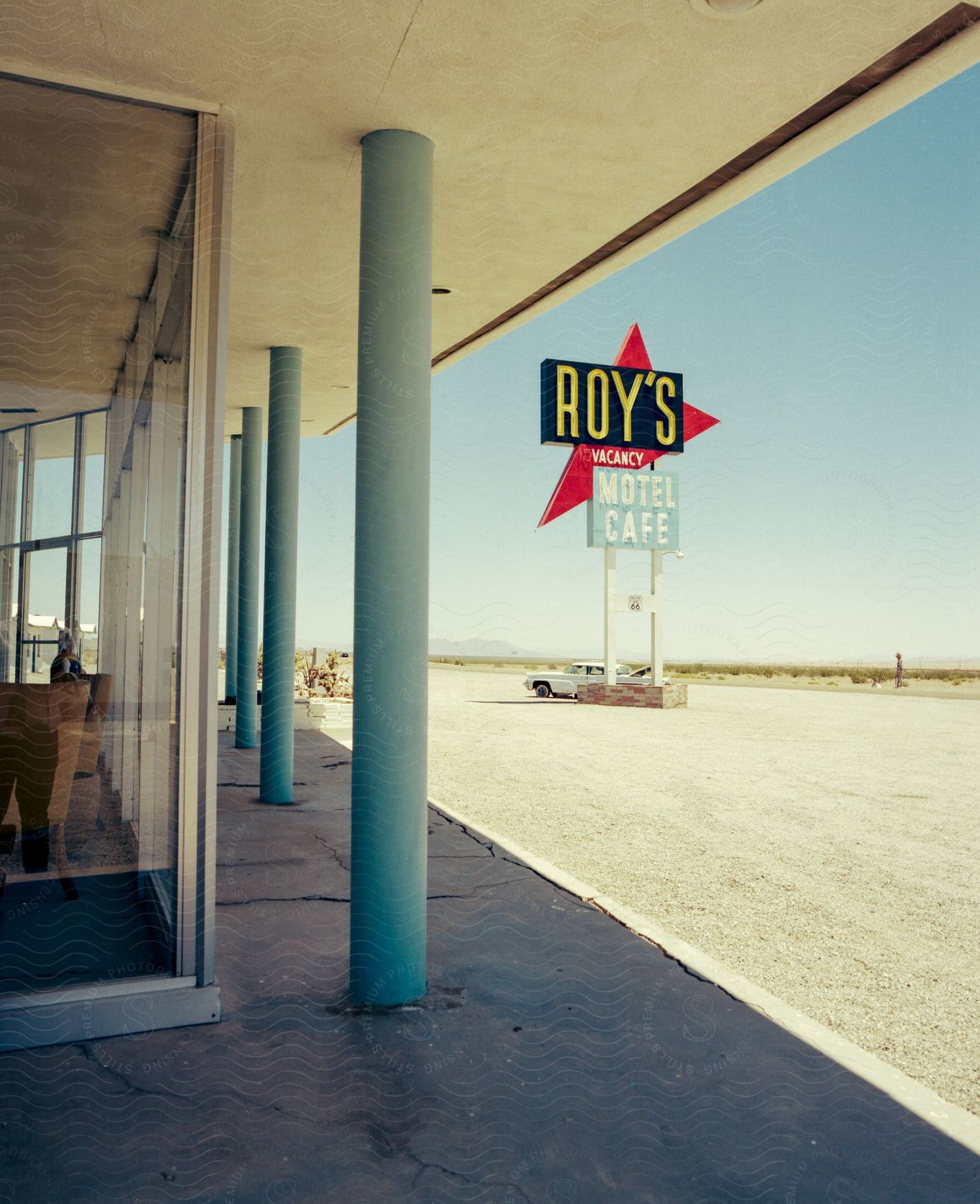 Exterior of motel building with a motel sign