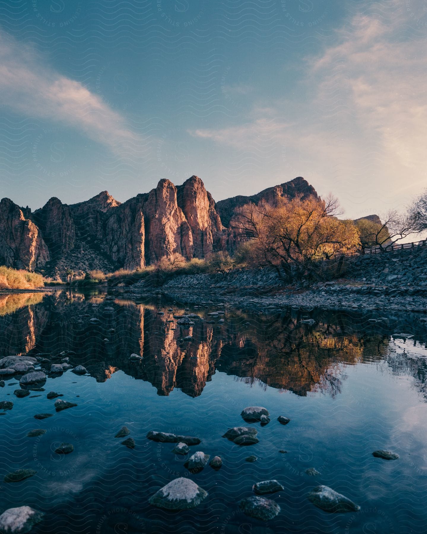 A landscape showing a small lake with wild mountains in the background