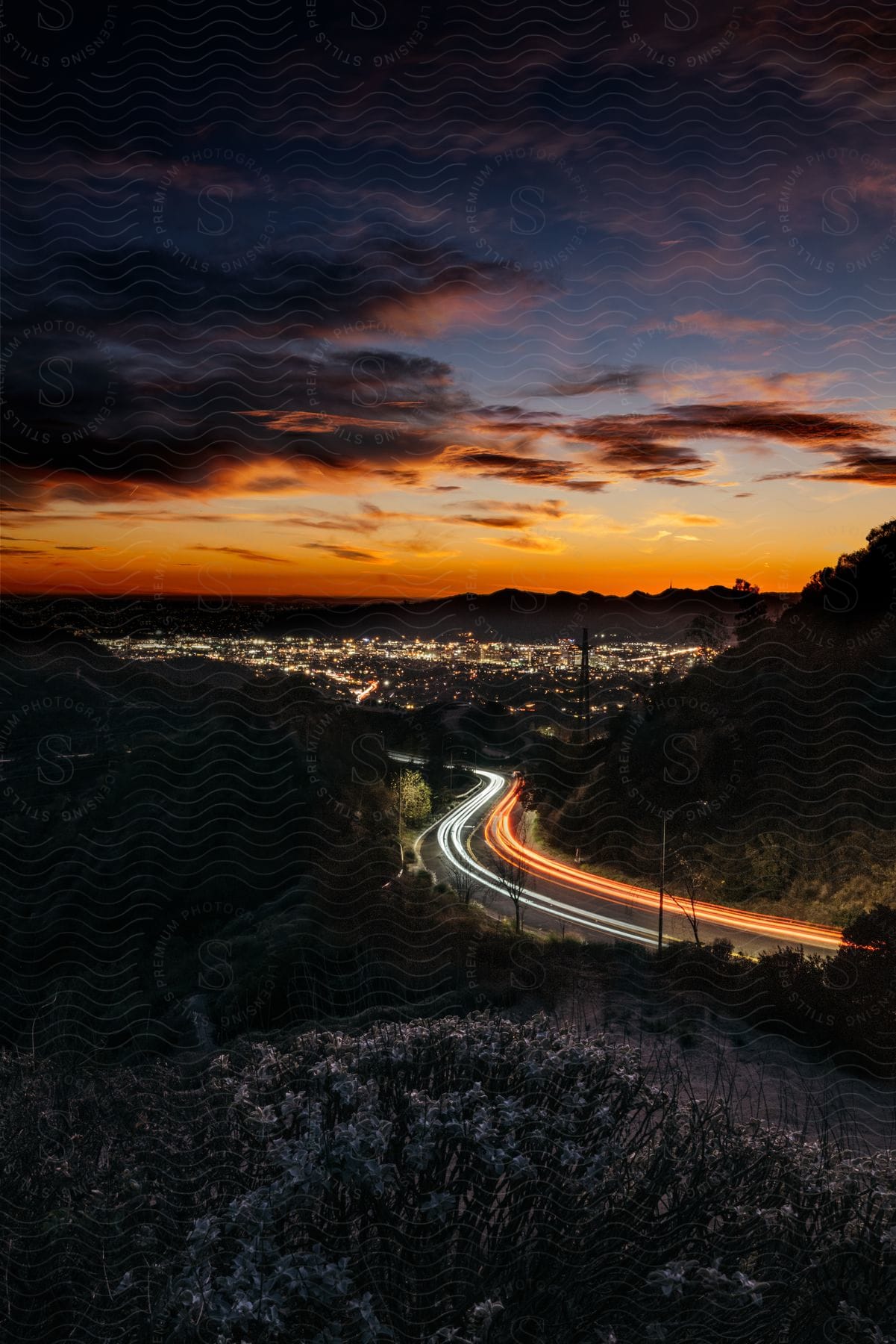 Sunset Over A Road And Cityscape At Dusk With Cloudy Sky And Neutral Atmosphere