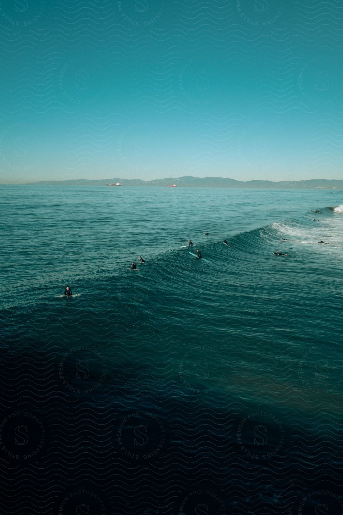 Several People On Surfboards Riding A Wave In The Ocean