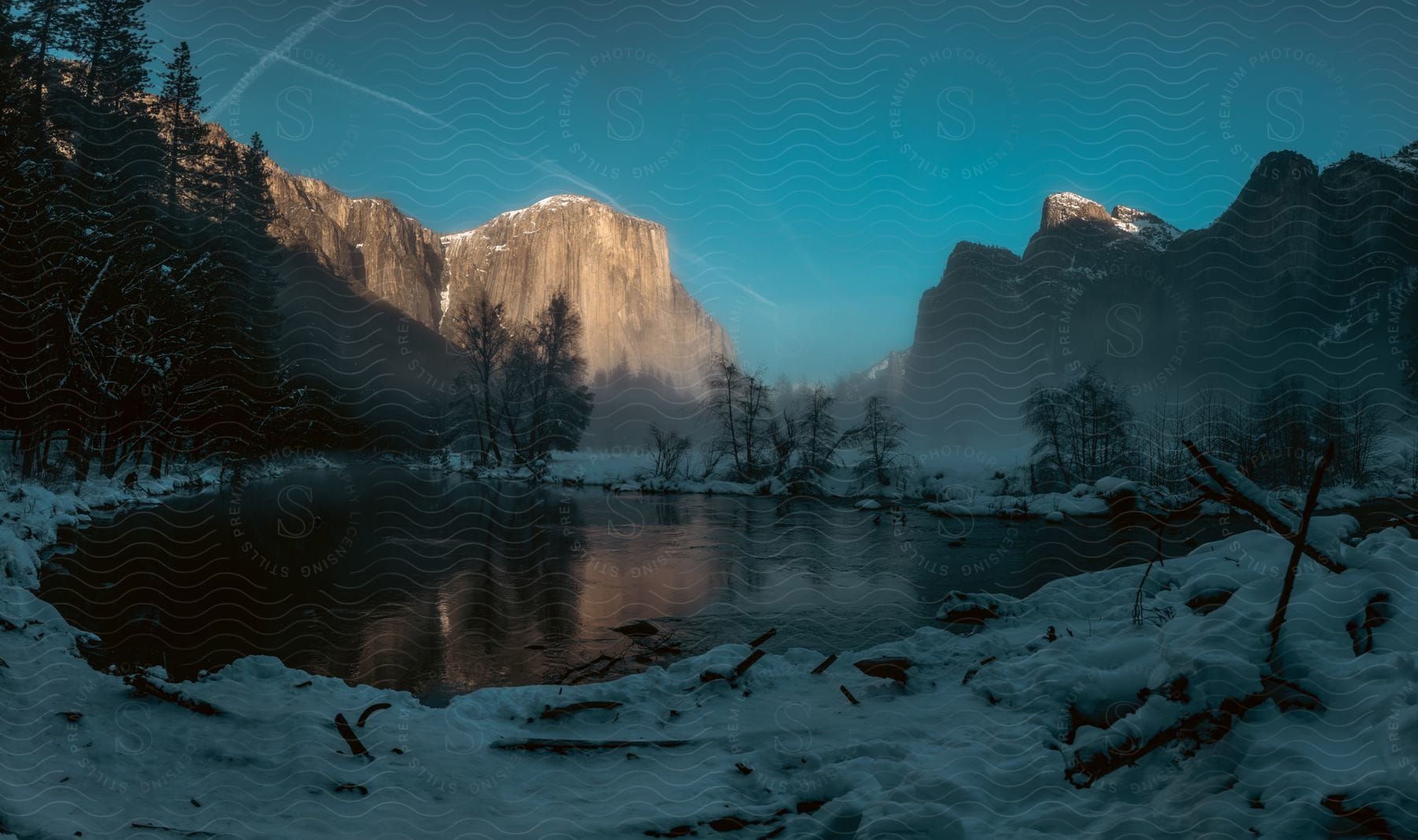 Snowcovered mountain landscape in the outdoors at dusk or dawn