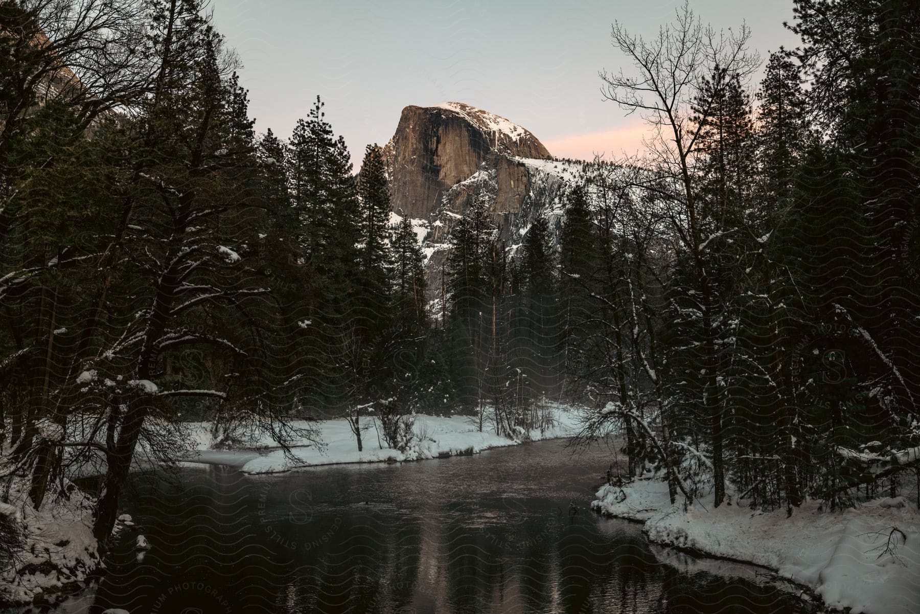 Sun setting above mountains during dusk