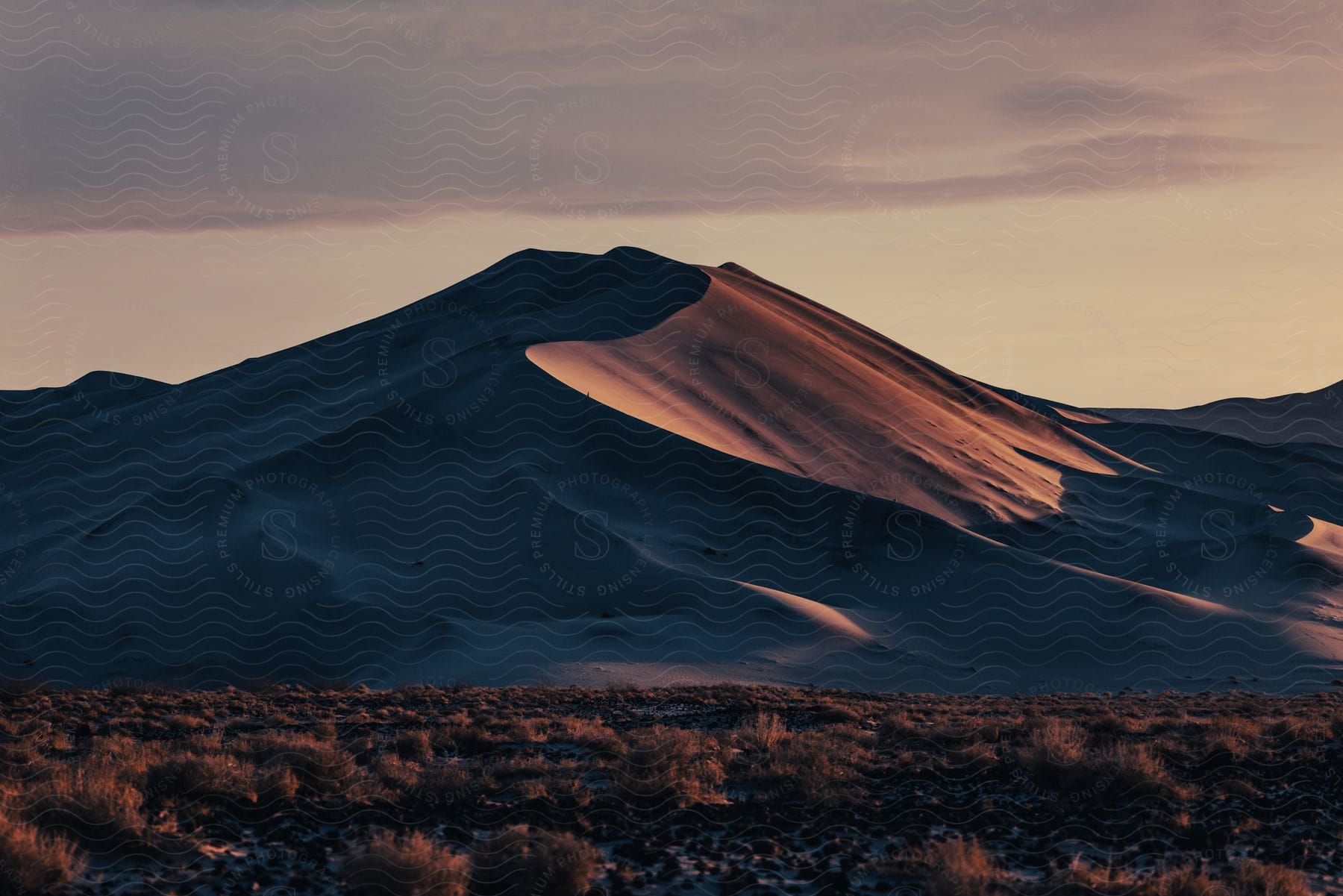 A serene mountainous landscape with clouds and a clear horizon