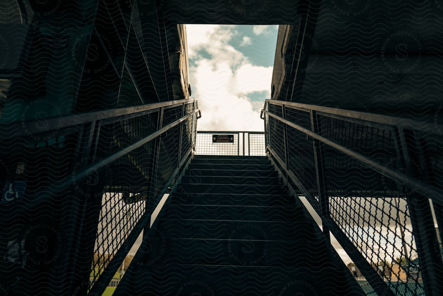 A metal staircase with the sky visible at the top