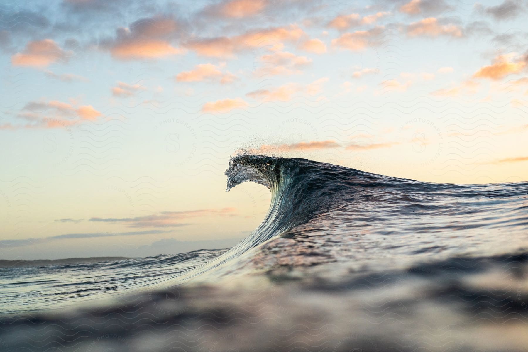 A closeup of ocean waves at sunset