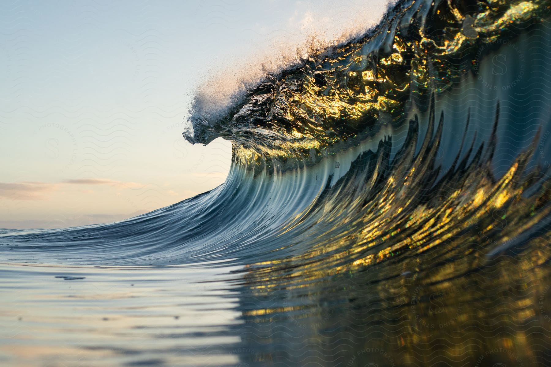 A closeup on a wave with sunlight reflections in the ocean