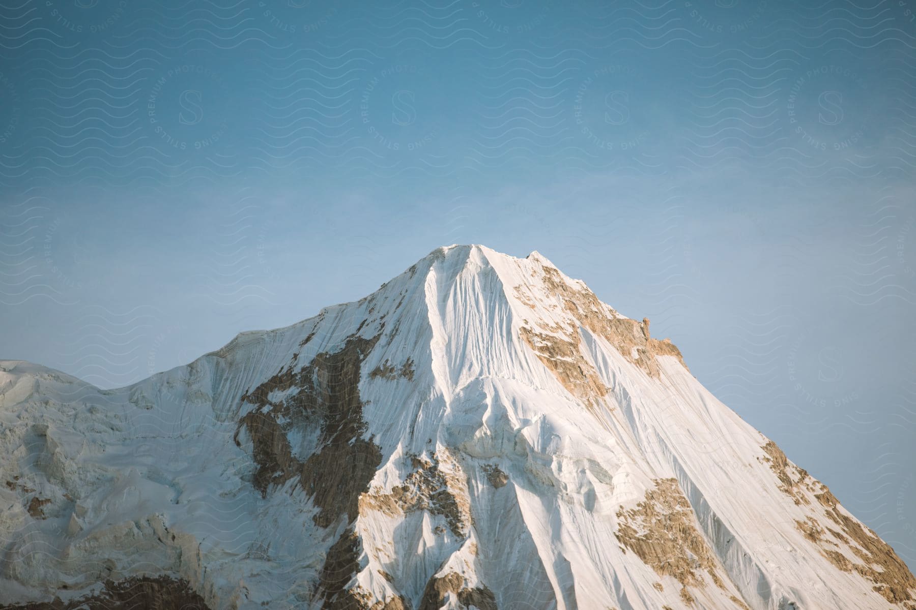 Snow covers a mountainside in the himalayan mountain range in pakistan