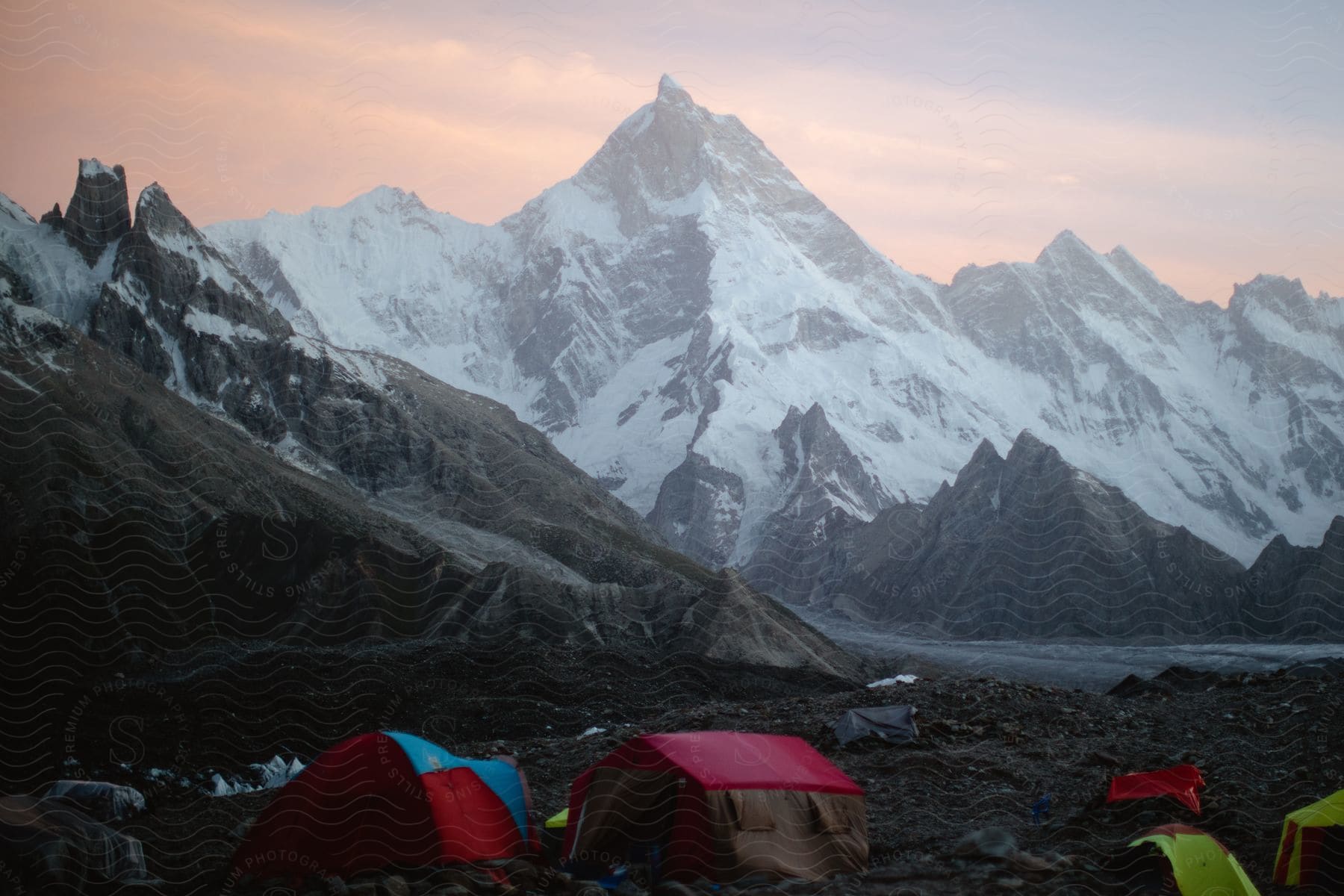 A campsite located at the base of a snowy mountain in the himalayan mountain landscapes of pakistan