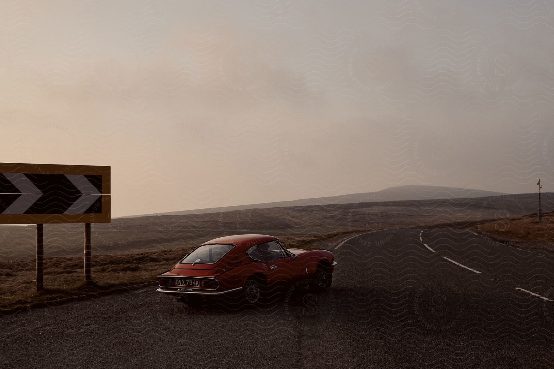 A vehicle on a road near the desert