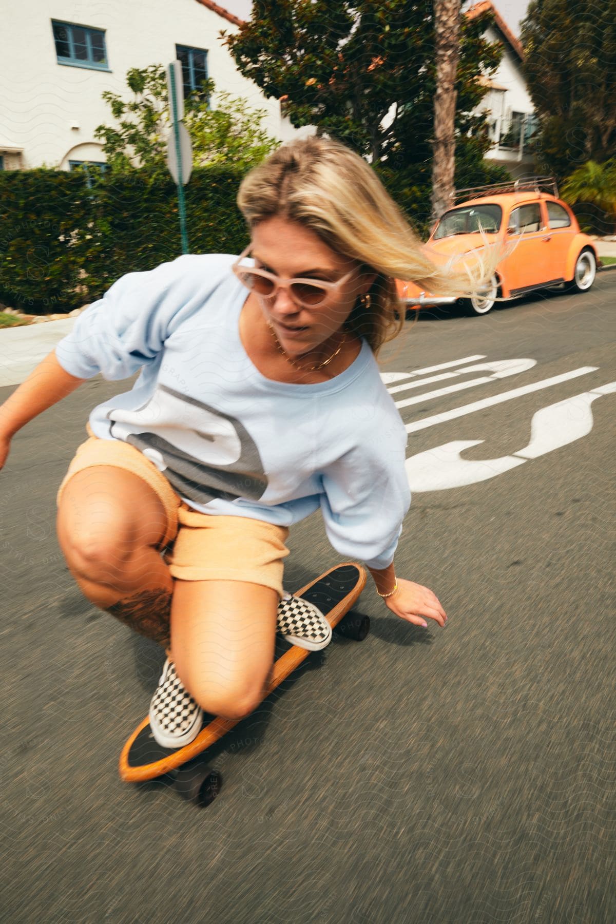 A happy woman skateboarding in an urban neighborhood