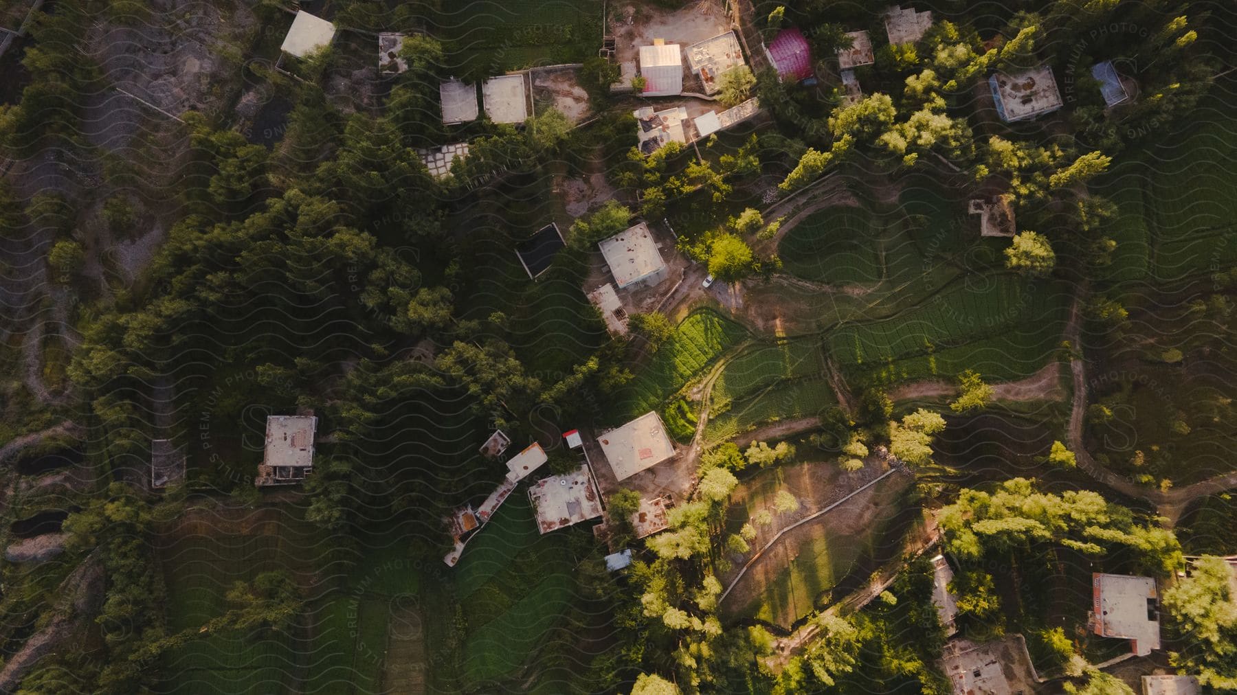 Aerial view of a rural village surrounded by mountains and vegetation