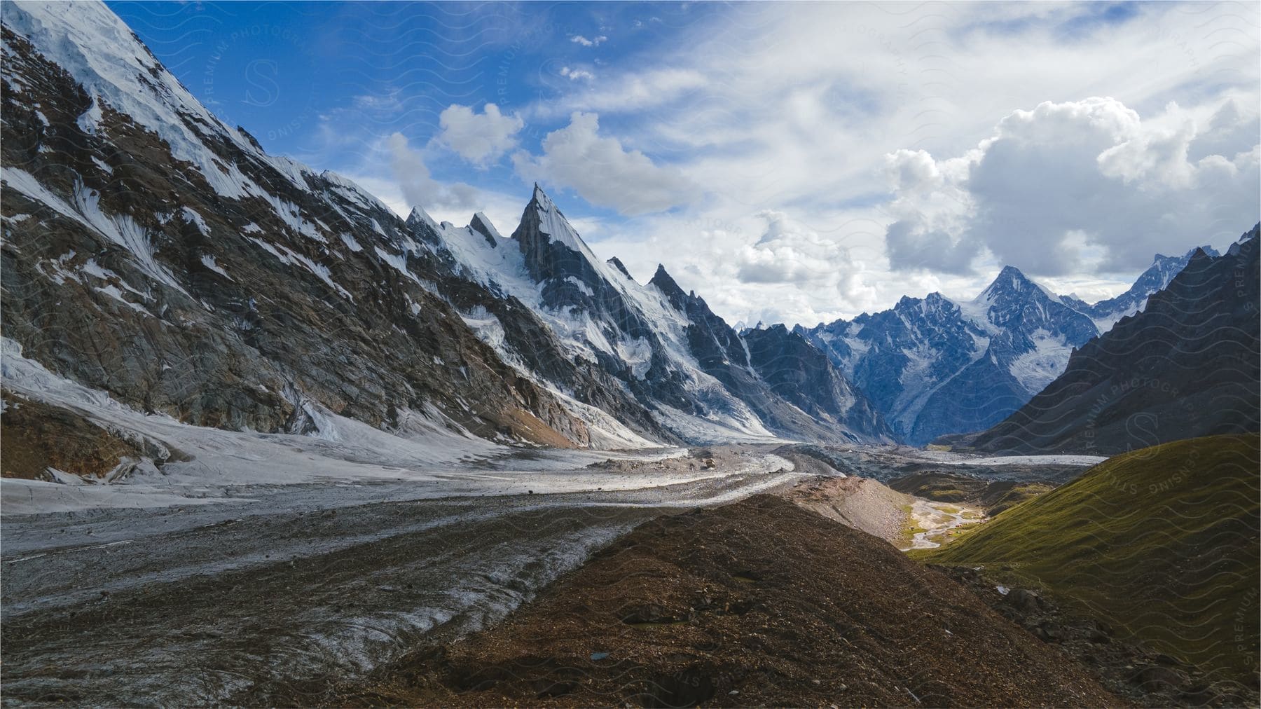 A road lies at the base of snowy mountains