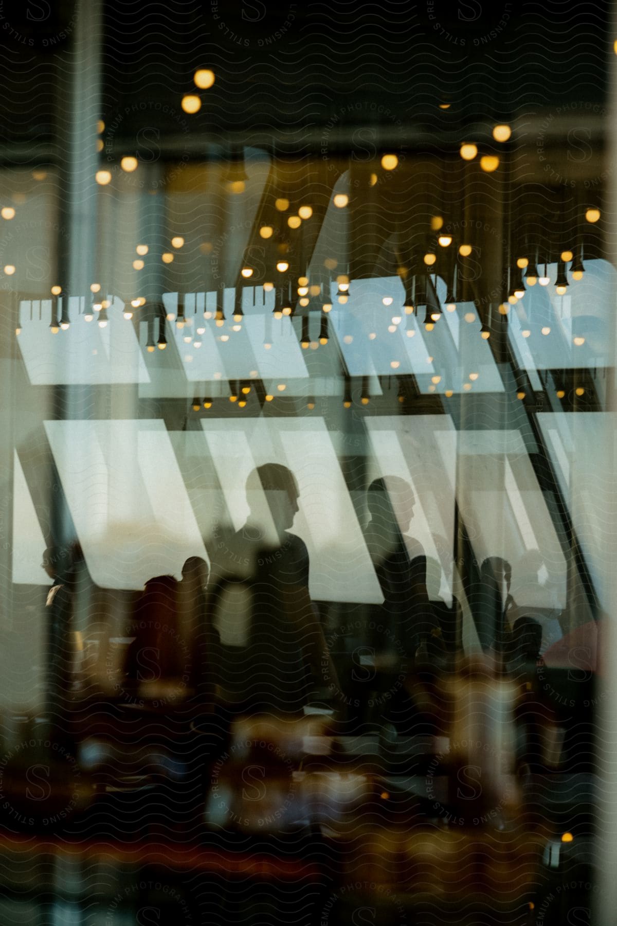 A group of people sitting at tables in the interior of a restaurant