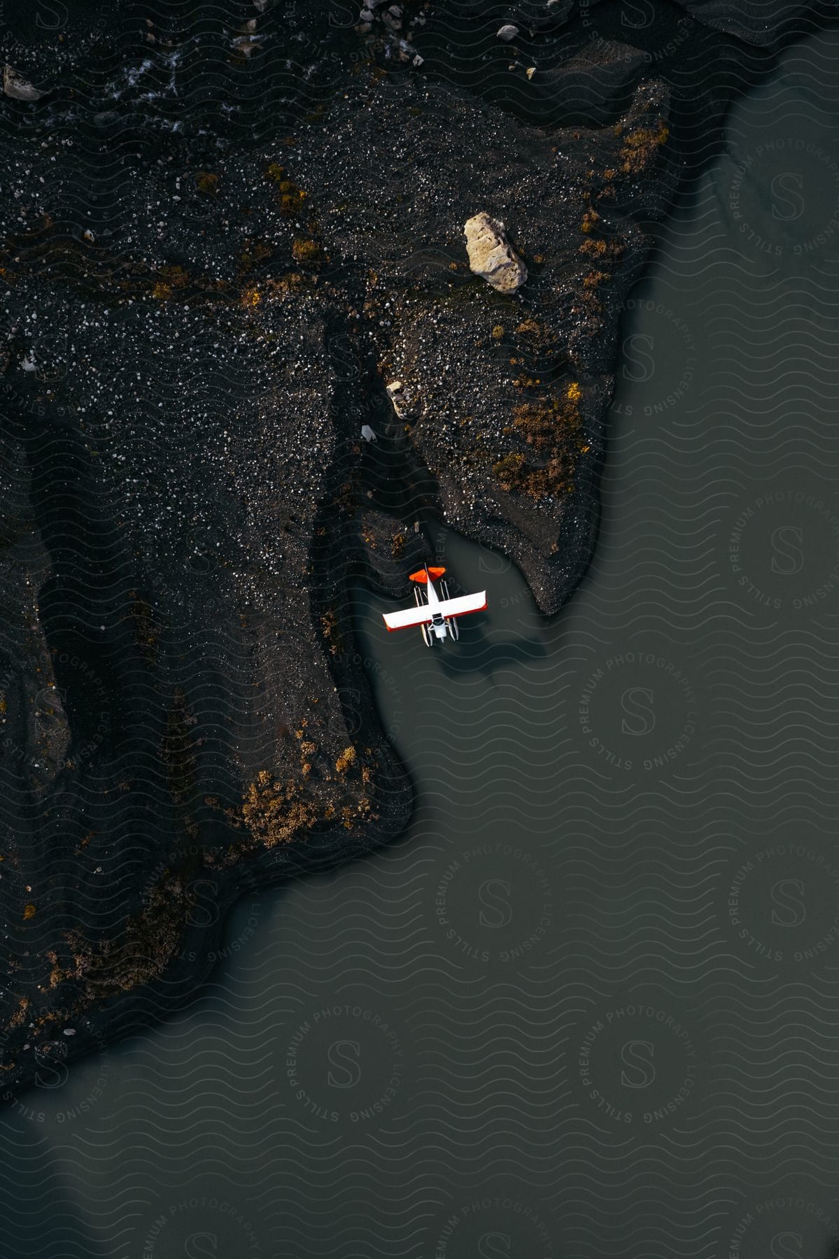 Prop plane parked on a shoreline