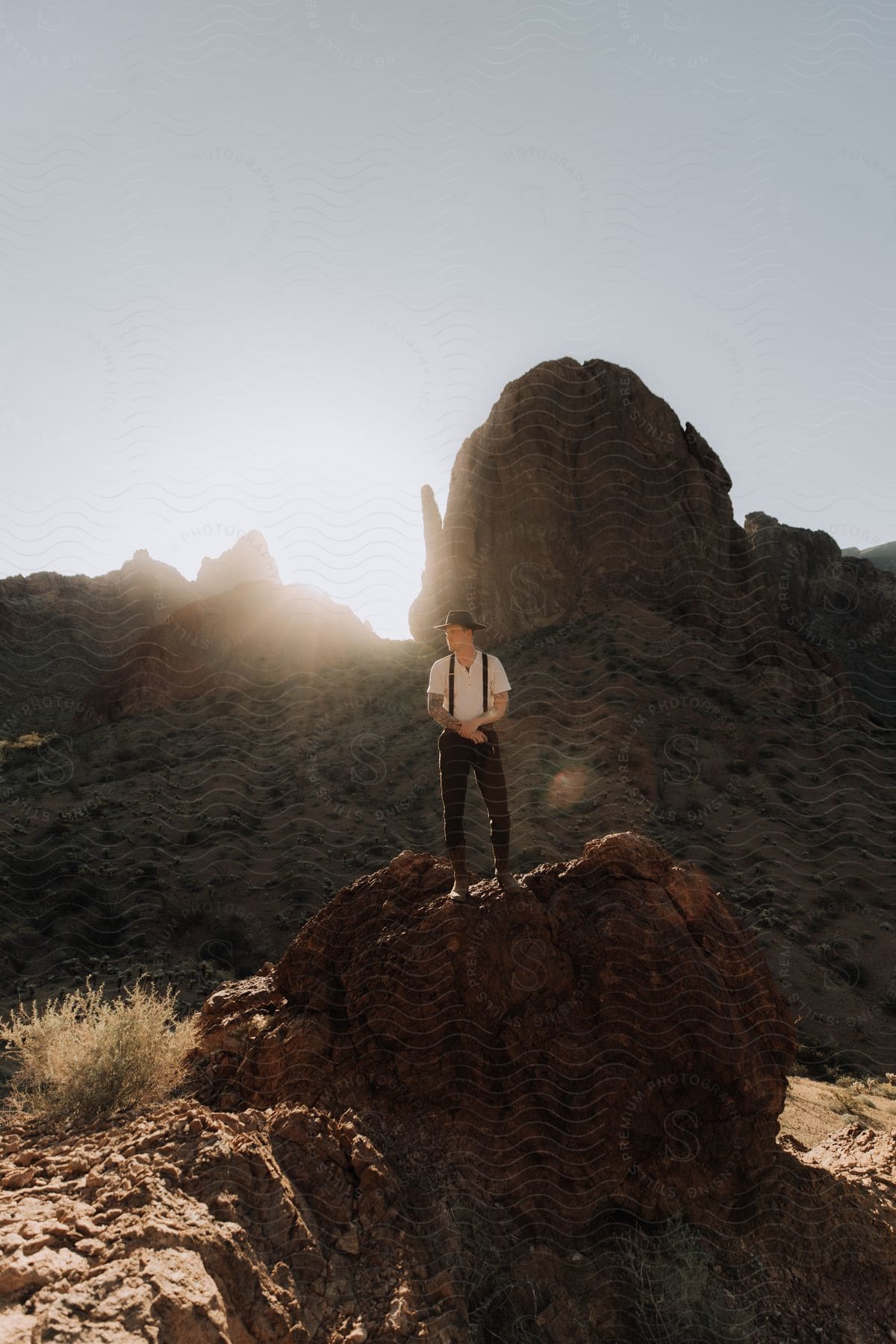 A person standing on a cliff in the wilderness