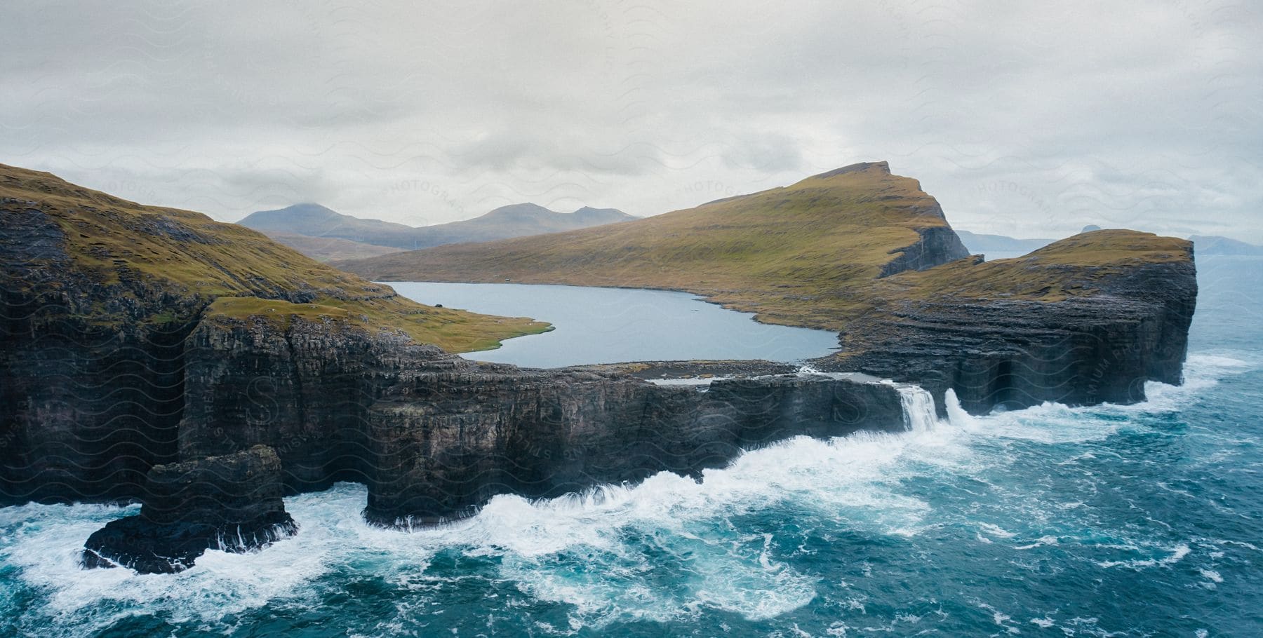 A lake perched on a cliff overlooking the ocean