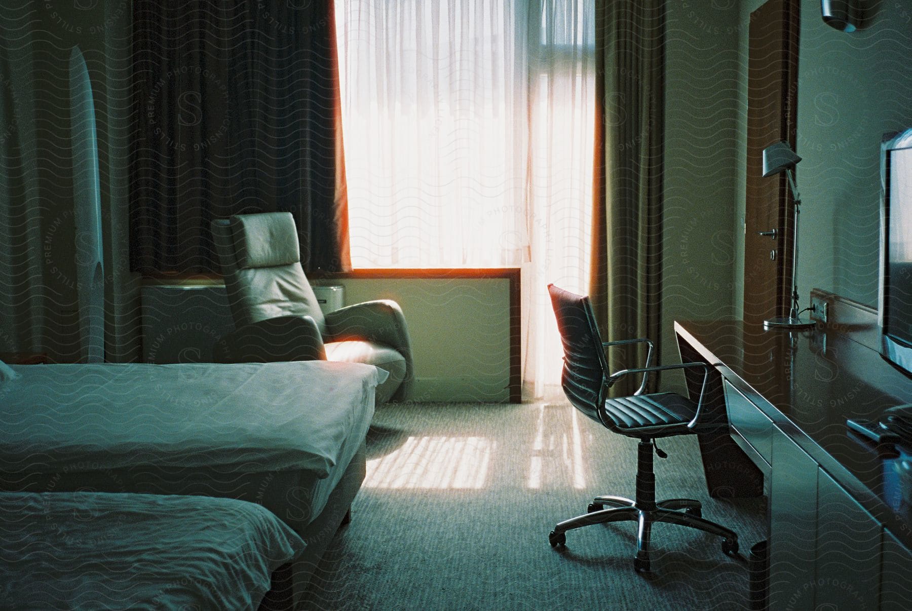 A hotel room with sunlight streaming in through the window