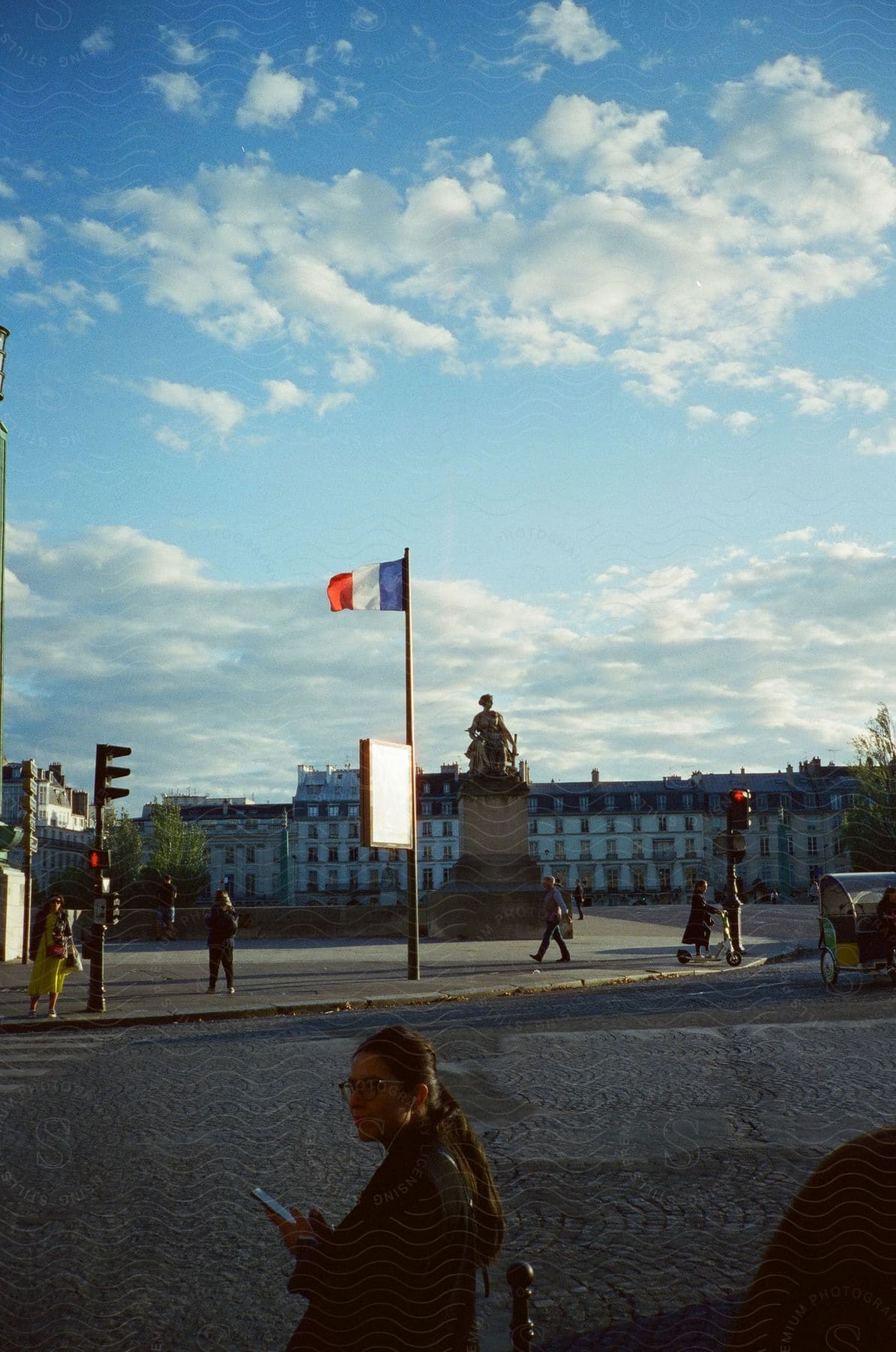 People walking in front of a statue in france