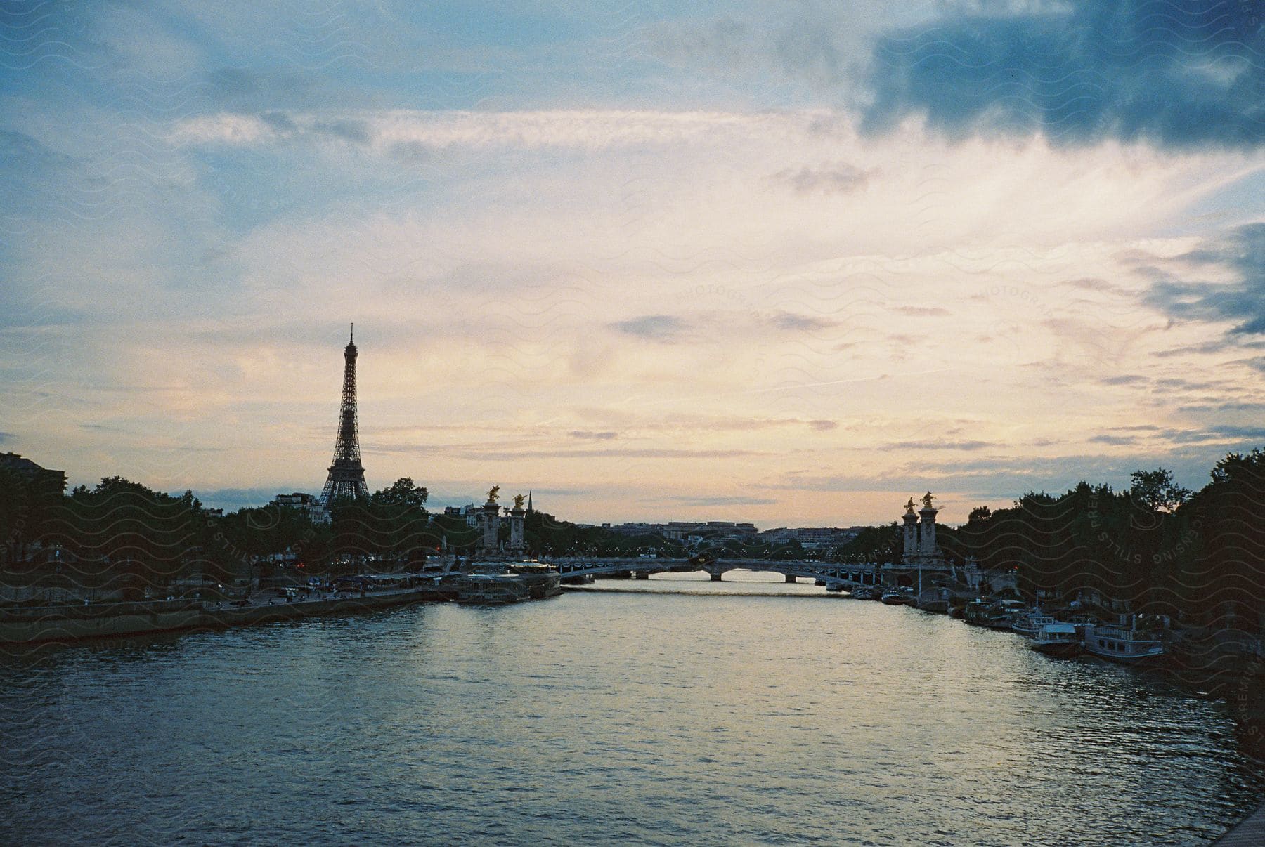 A canal in paris with the eiffel tower in the background