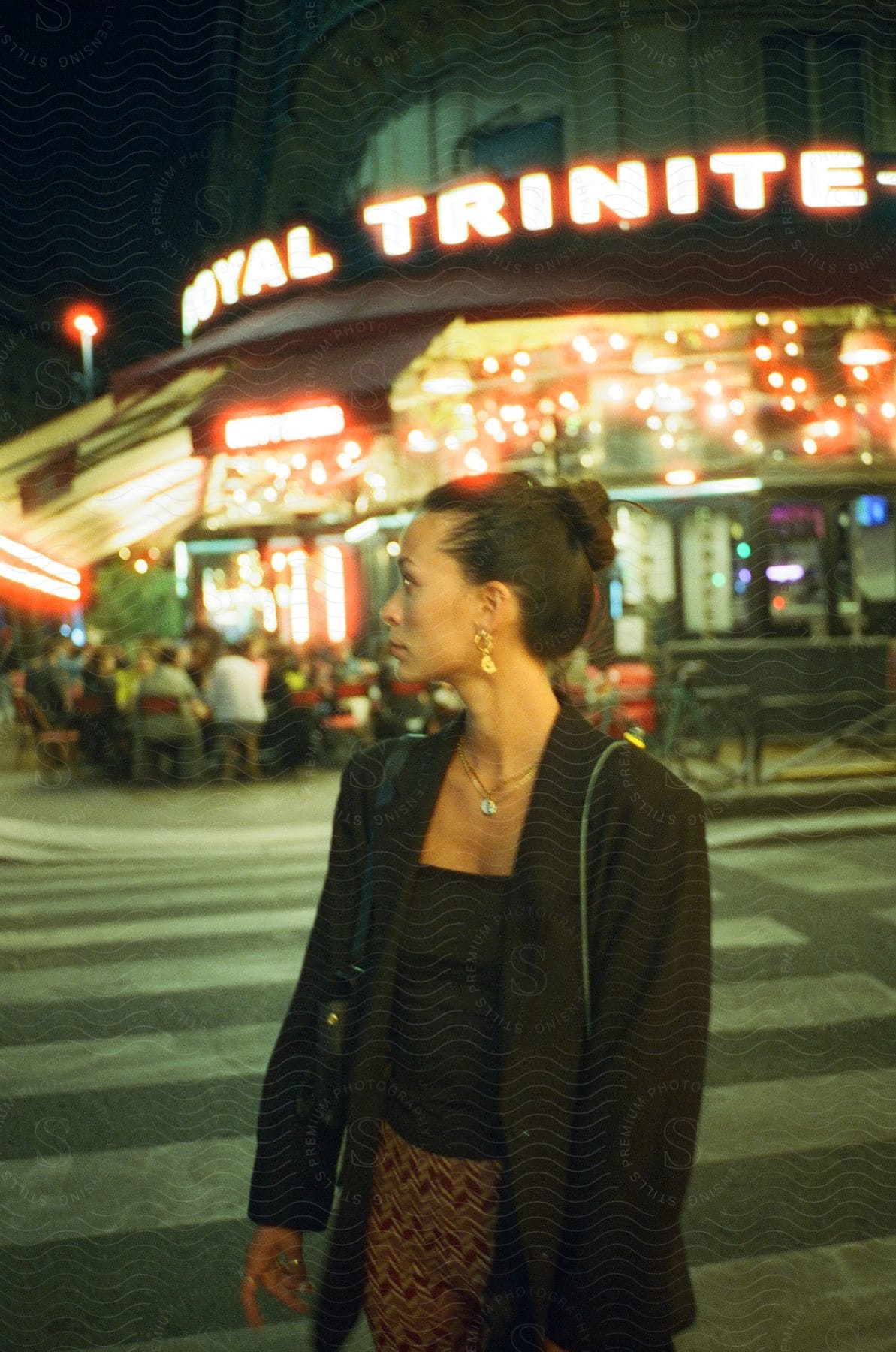 A woman crossing the street at night in paris