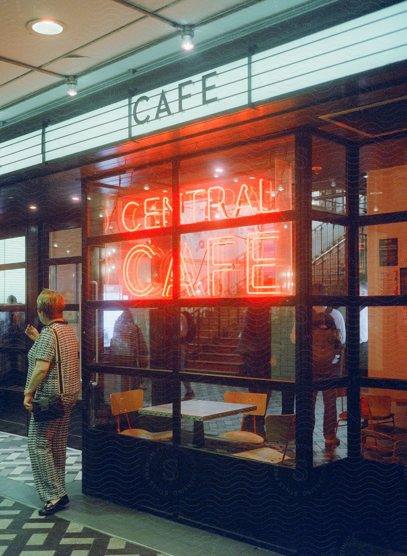 Exterior of a cafe at night with a neon sign
