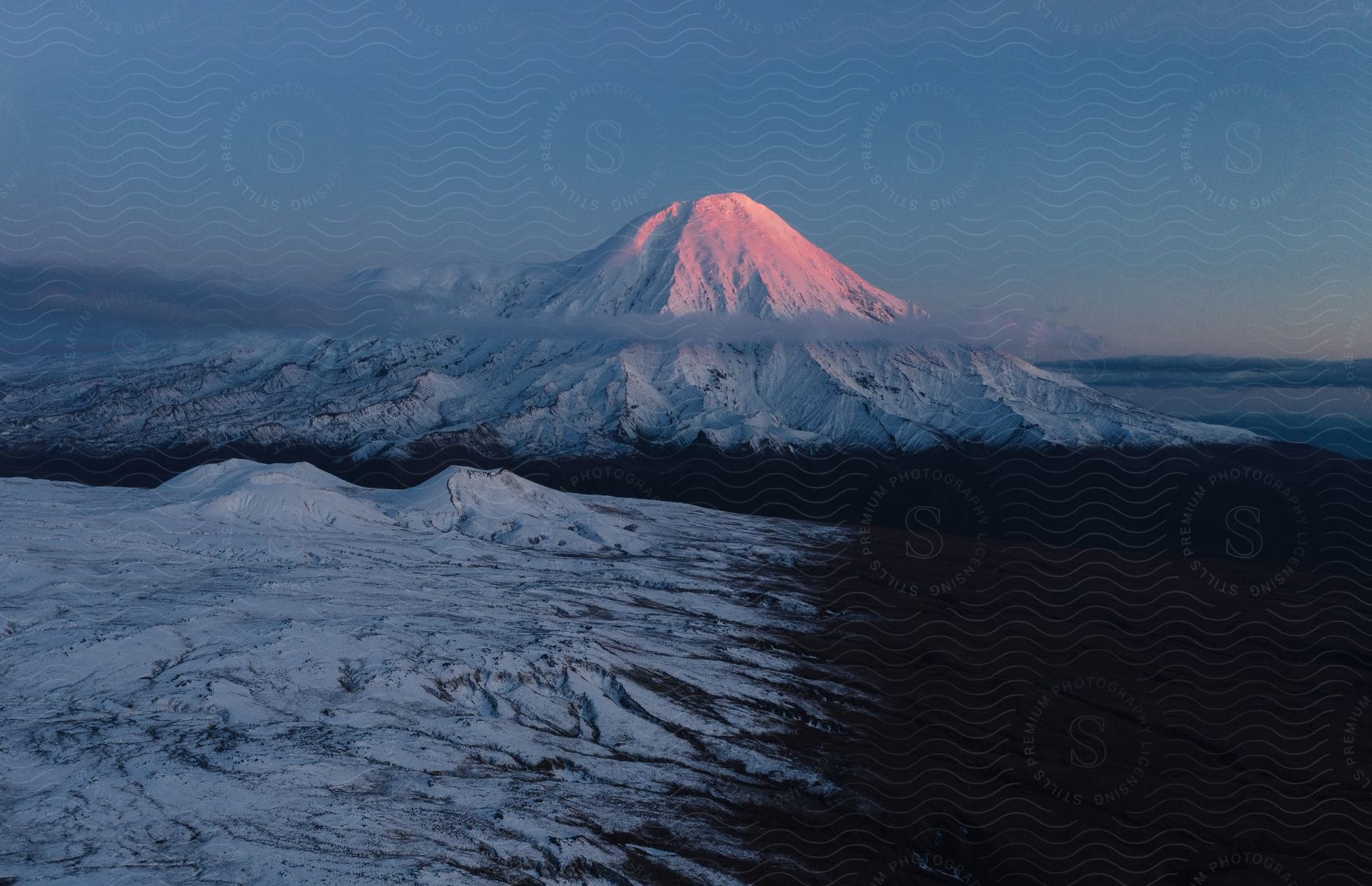 Evening Sun Shines On Snowy Mountain Peak