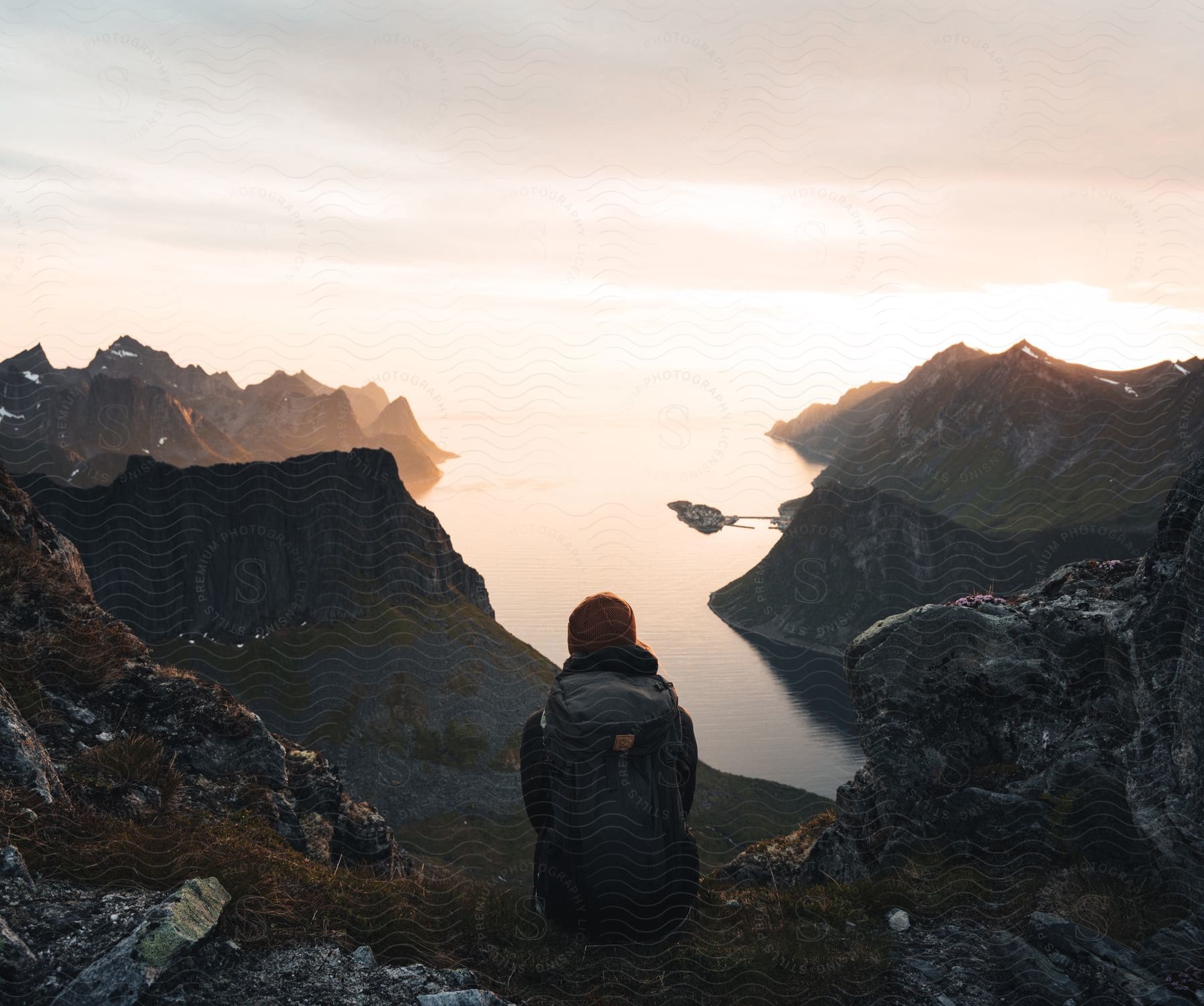 A Person Sitting On The Ground Looking At The Ocean