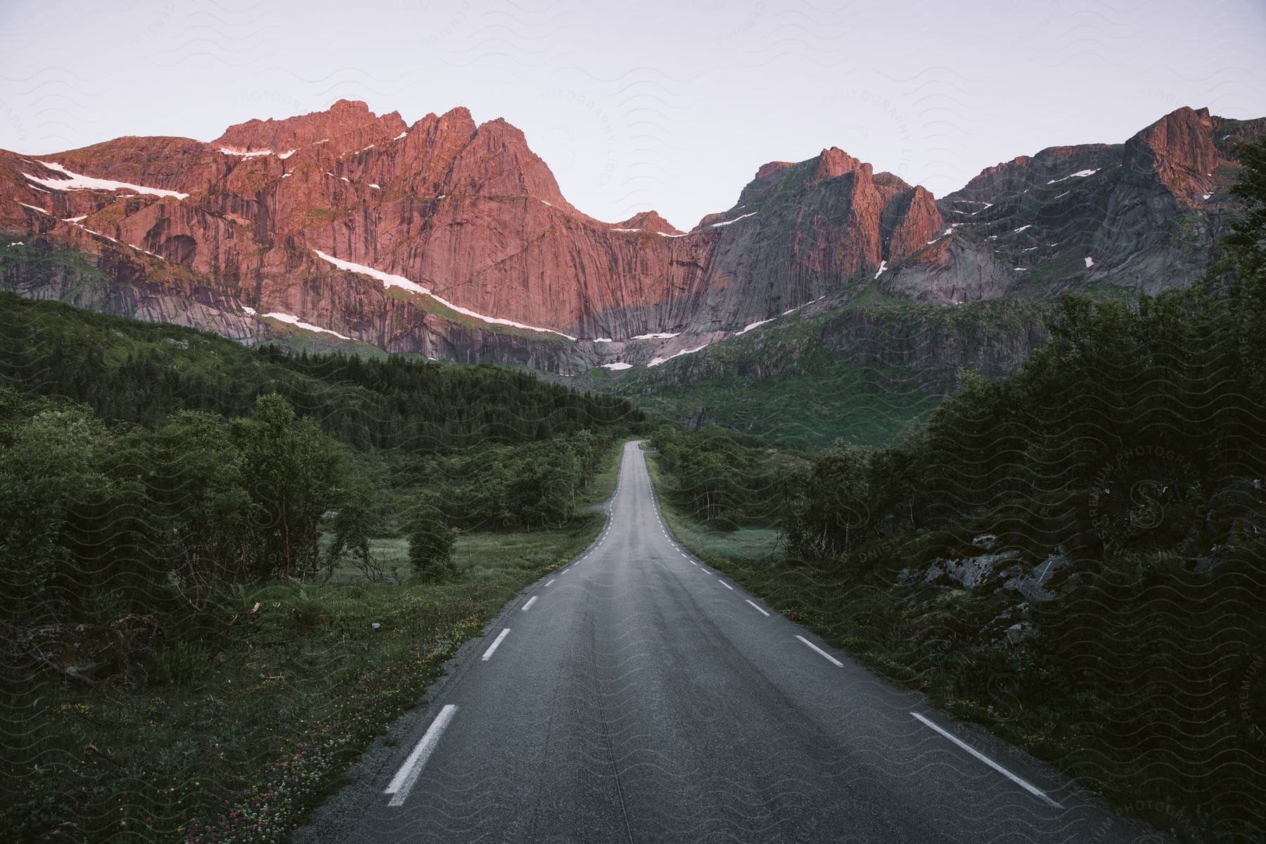 Country road and mountain range at sunset