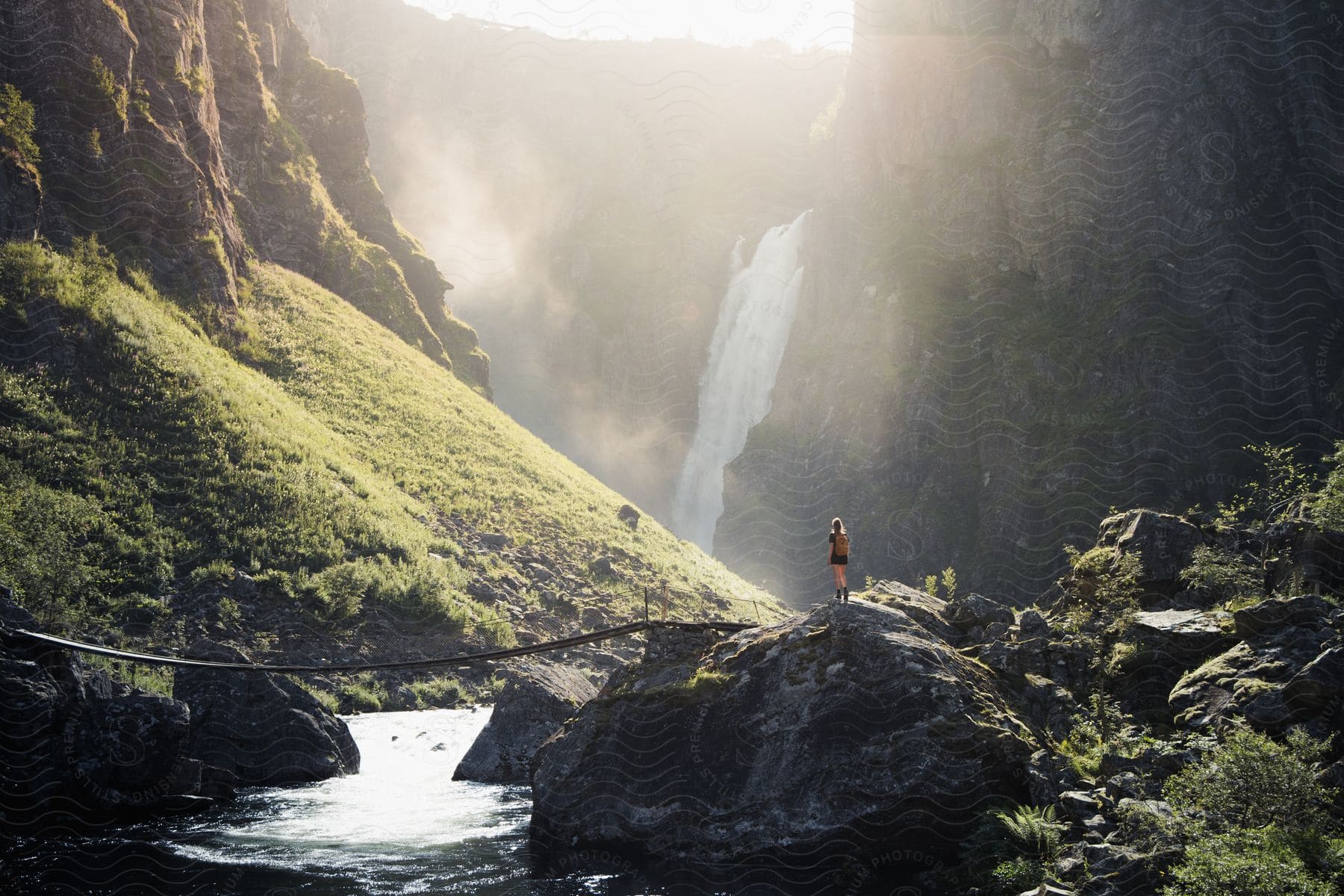 A person in nature near a waterfall in norway