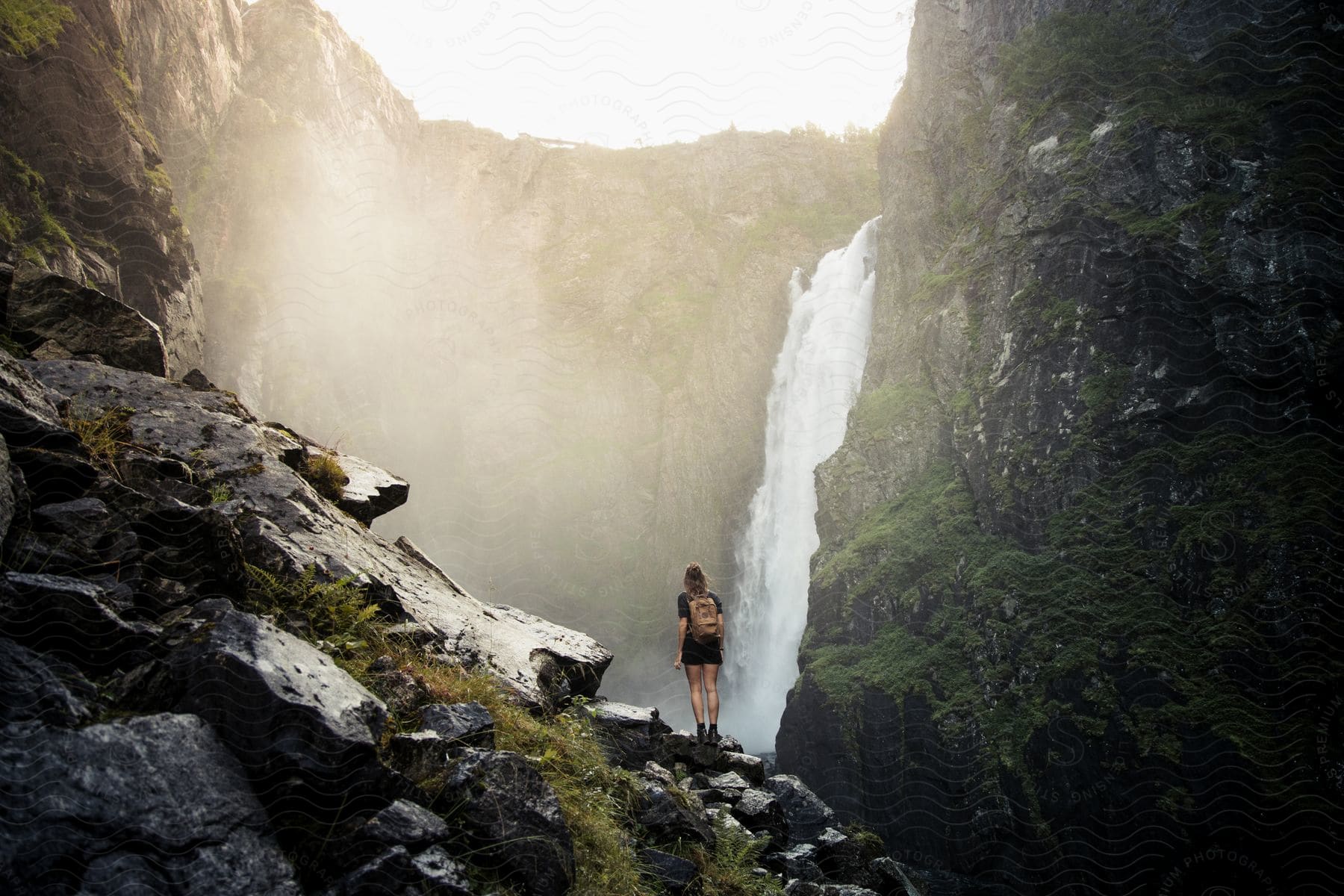 A person standing on a cliff observing the scenery