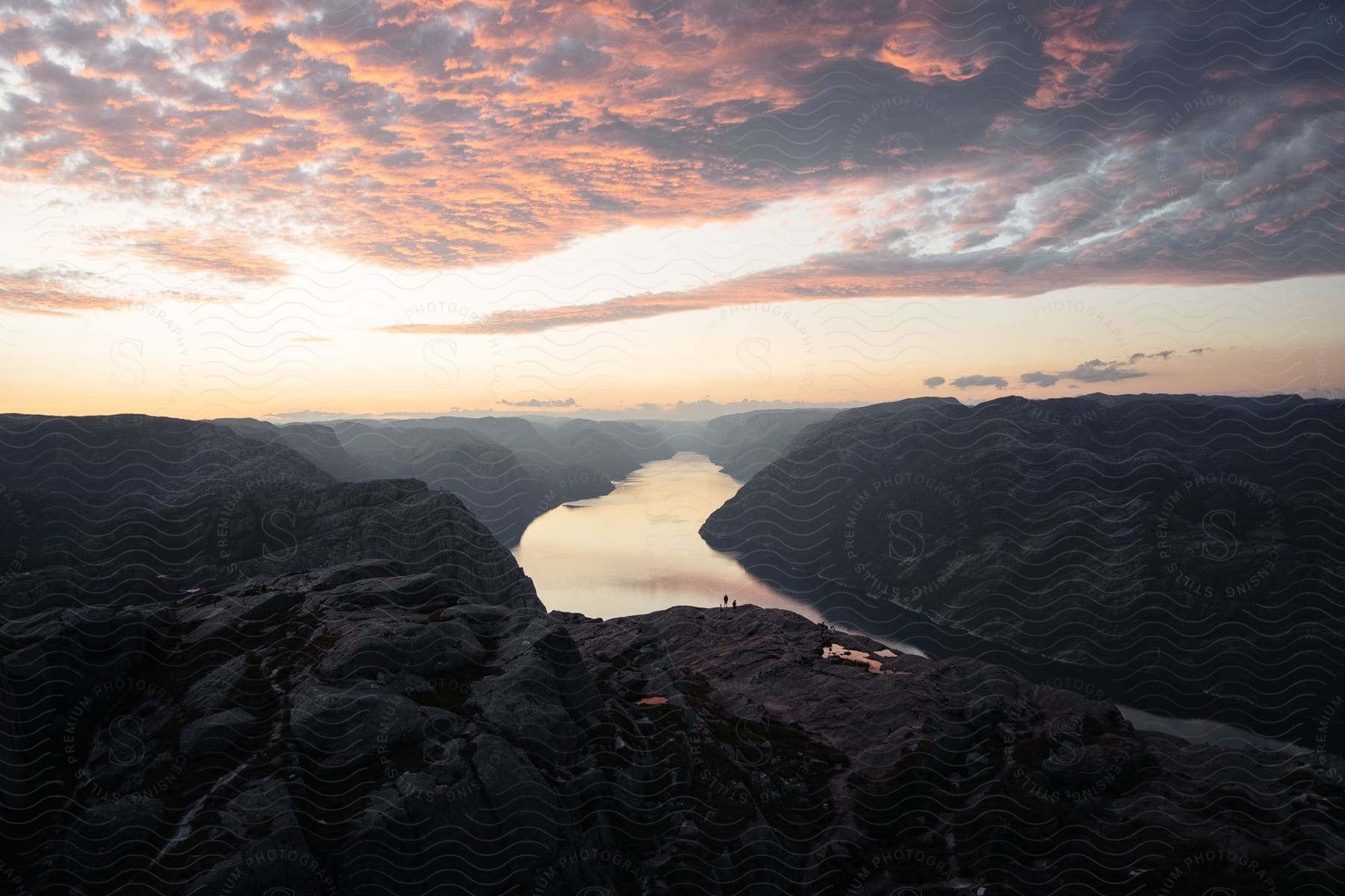 Aerial view of a river winding through mountains at dusk in norway