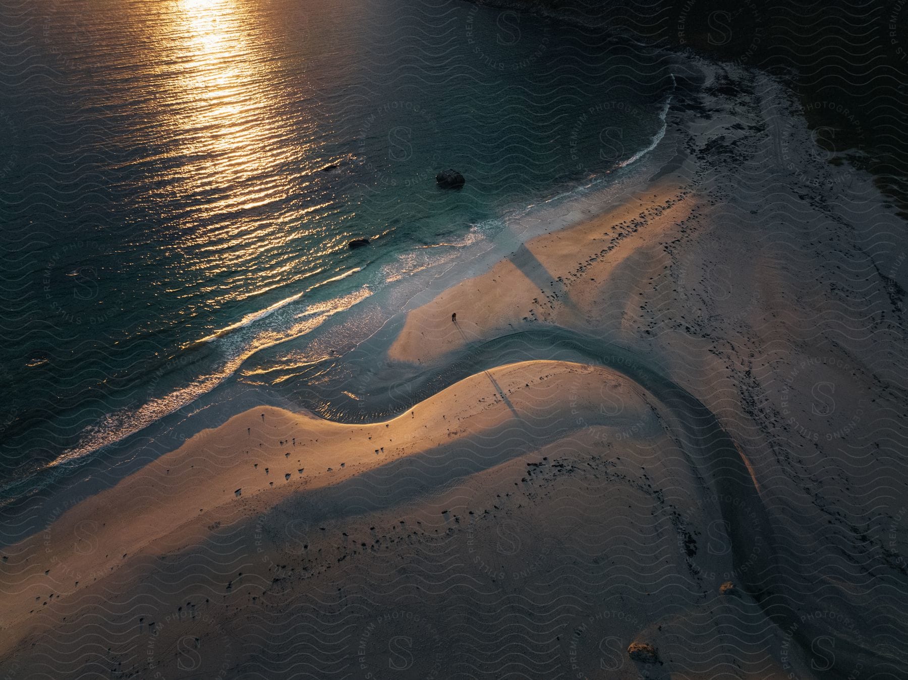 Aerial view of a coastal shoreline at dusk in norway during the summer with clouds and water visible