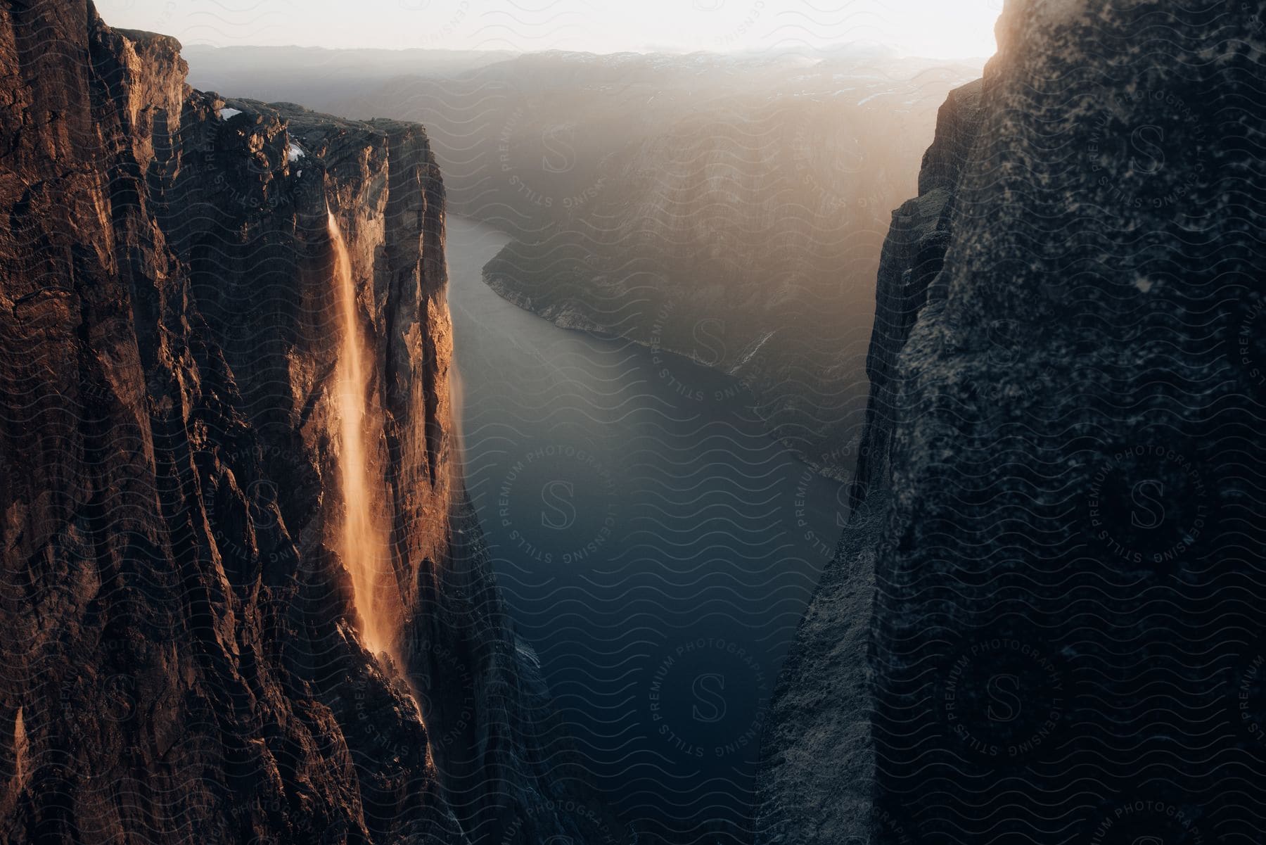 Stock photo of a hazy sky shines on a mountain river canyon under the sun