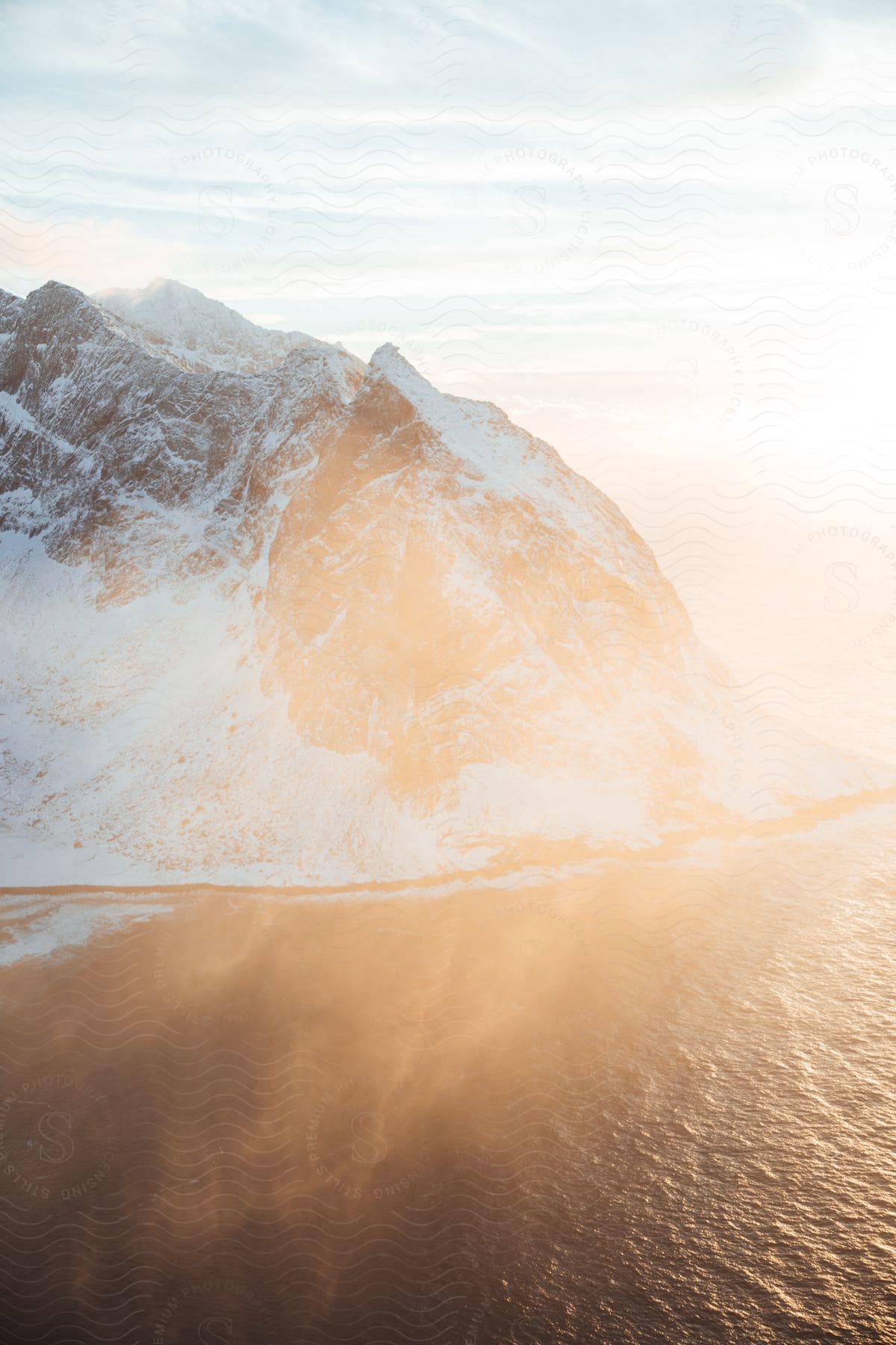 A serene winter landscape in norway with mountains water and a clear sky