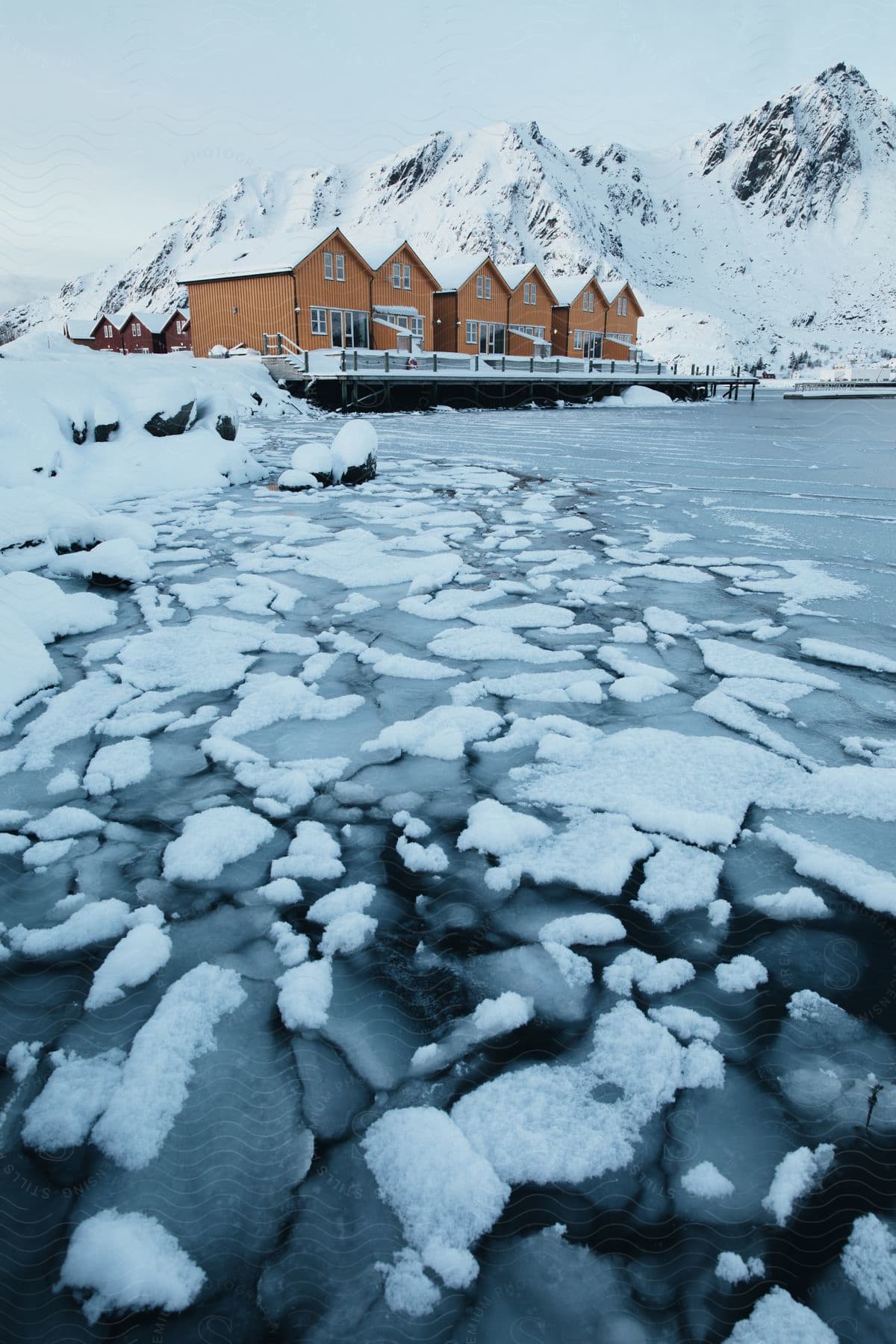 A frozen landscape in norway with mountains water and ice