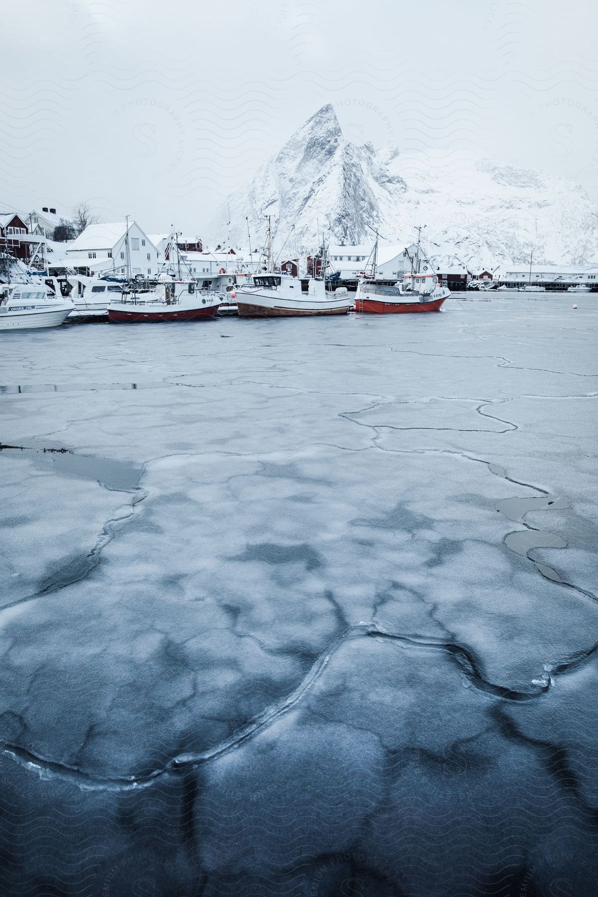 A winter scene in norway with mountains water and a boat
