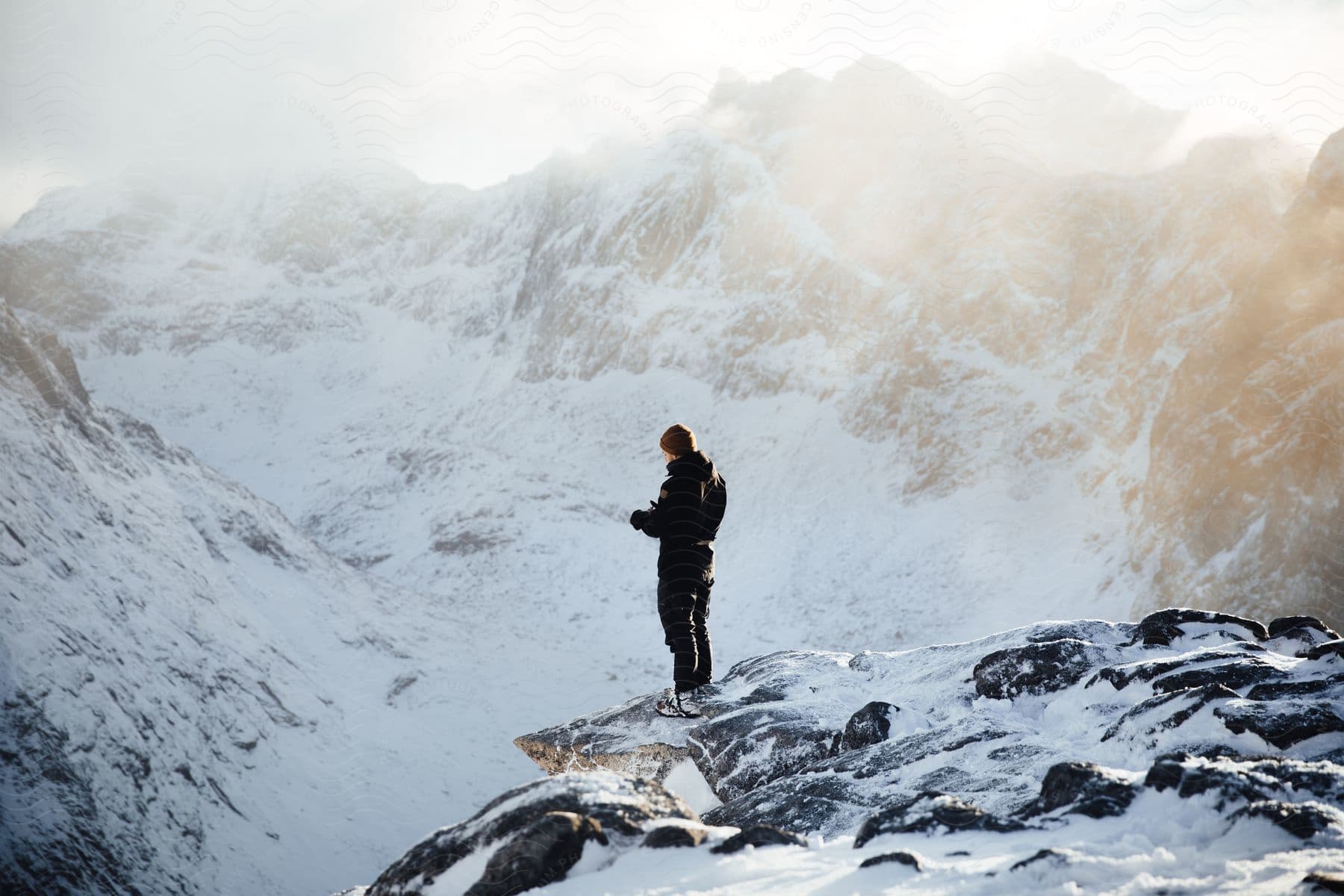 A person standing in the snowy mountains