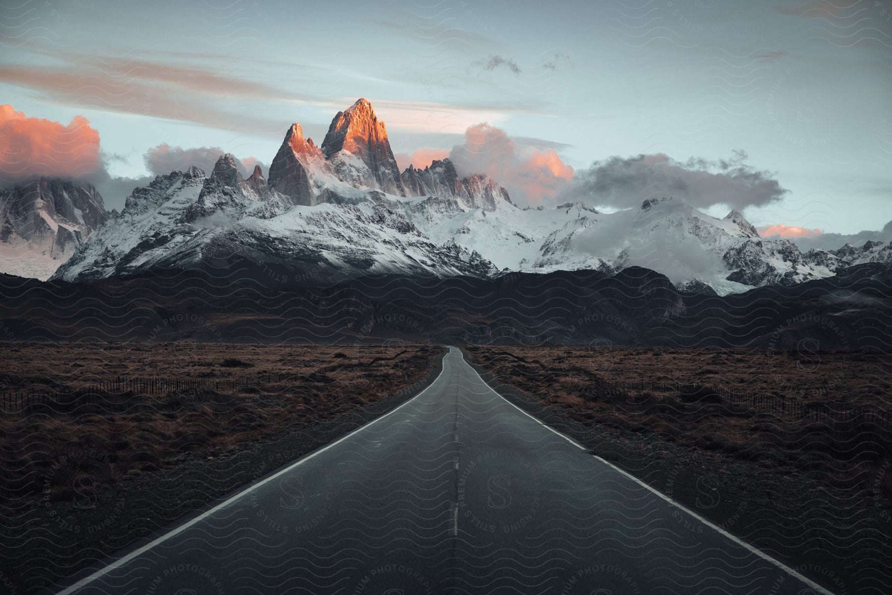 A road leading to a mountain landscape at dusk