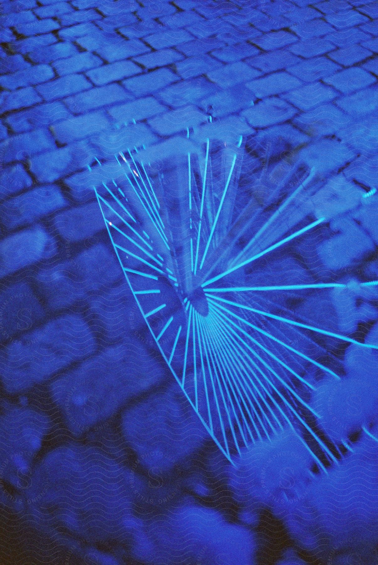 A stack of blue bricks with a spoked image in the center