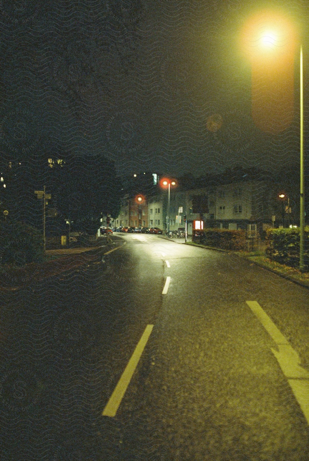 Cars parked on a street near apartment buildings