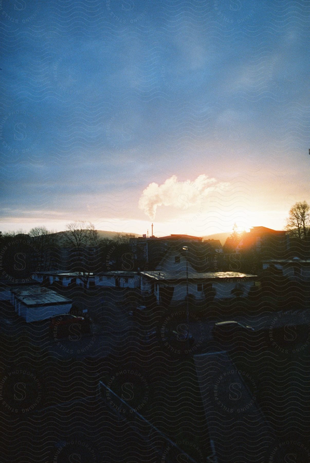 A colorful dawn view of a community with houses and a vibrant sky