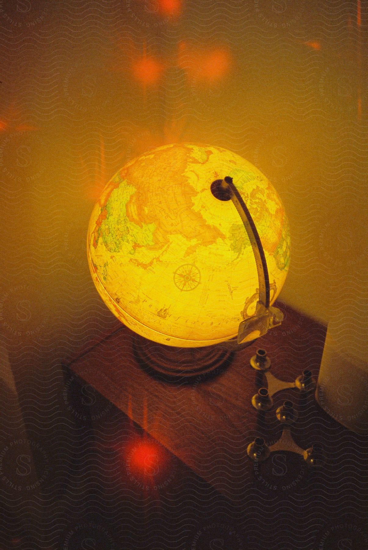 A wooden table with an ambercolored sphere