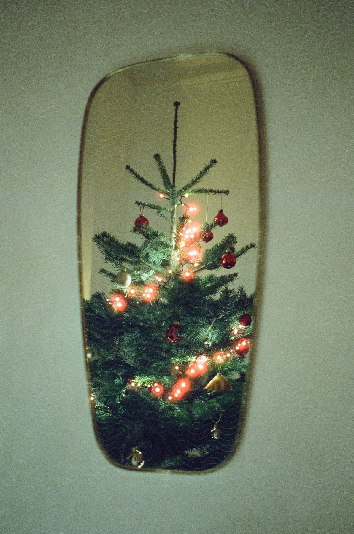 Christmas Tree Reflected In A Wall Mirror