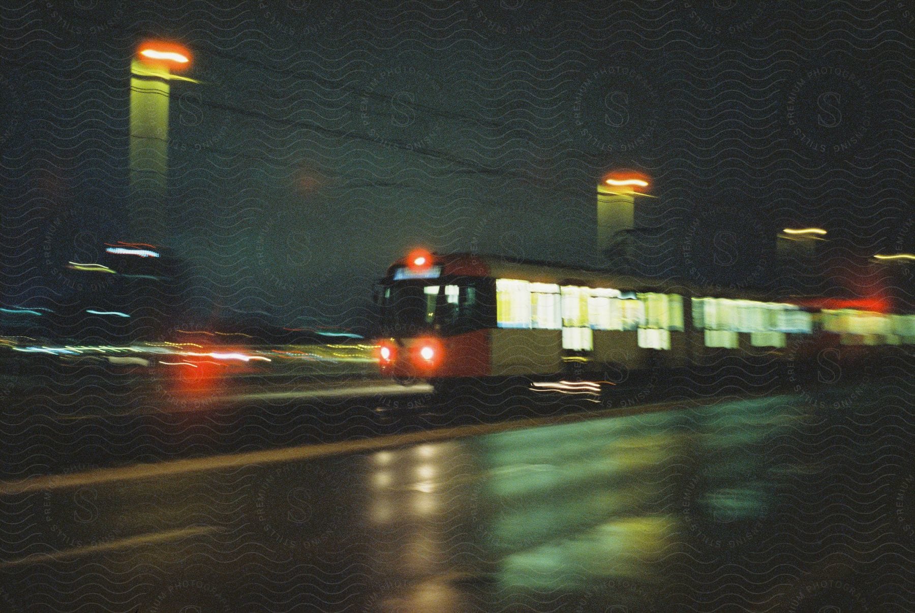 A train on a road with street lights