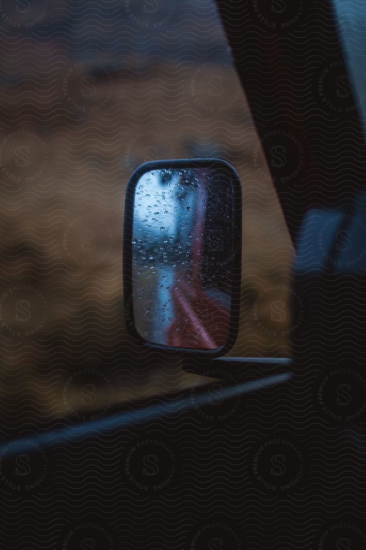 Rear view mirror of a vehicle with water droplets