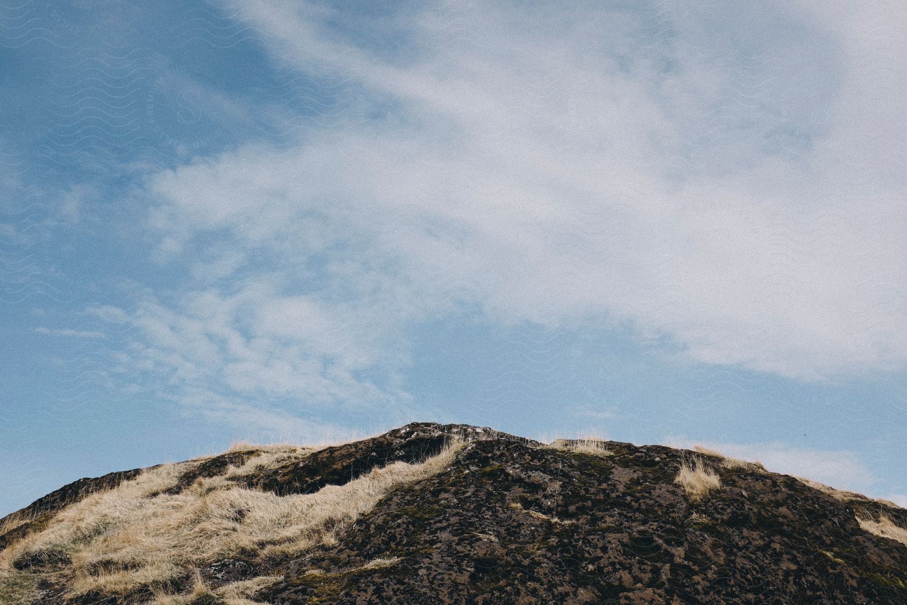 Barren mountain top under a blue sky