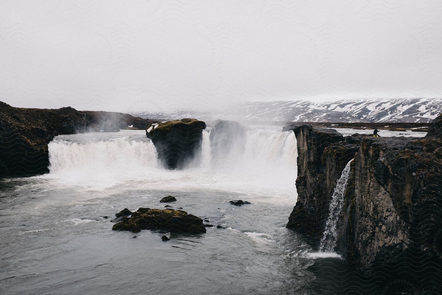 A serene natural landscape with a lake water and a waterfall